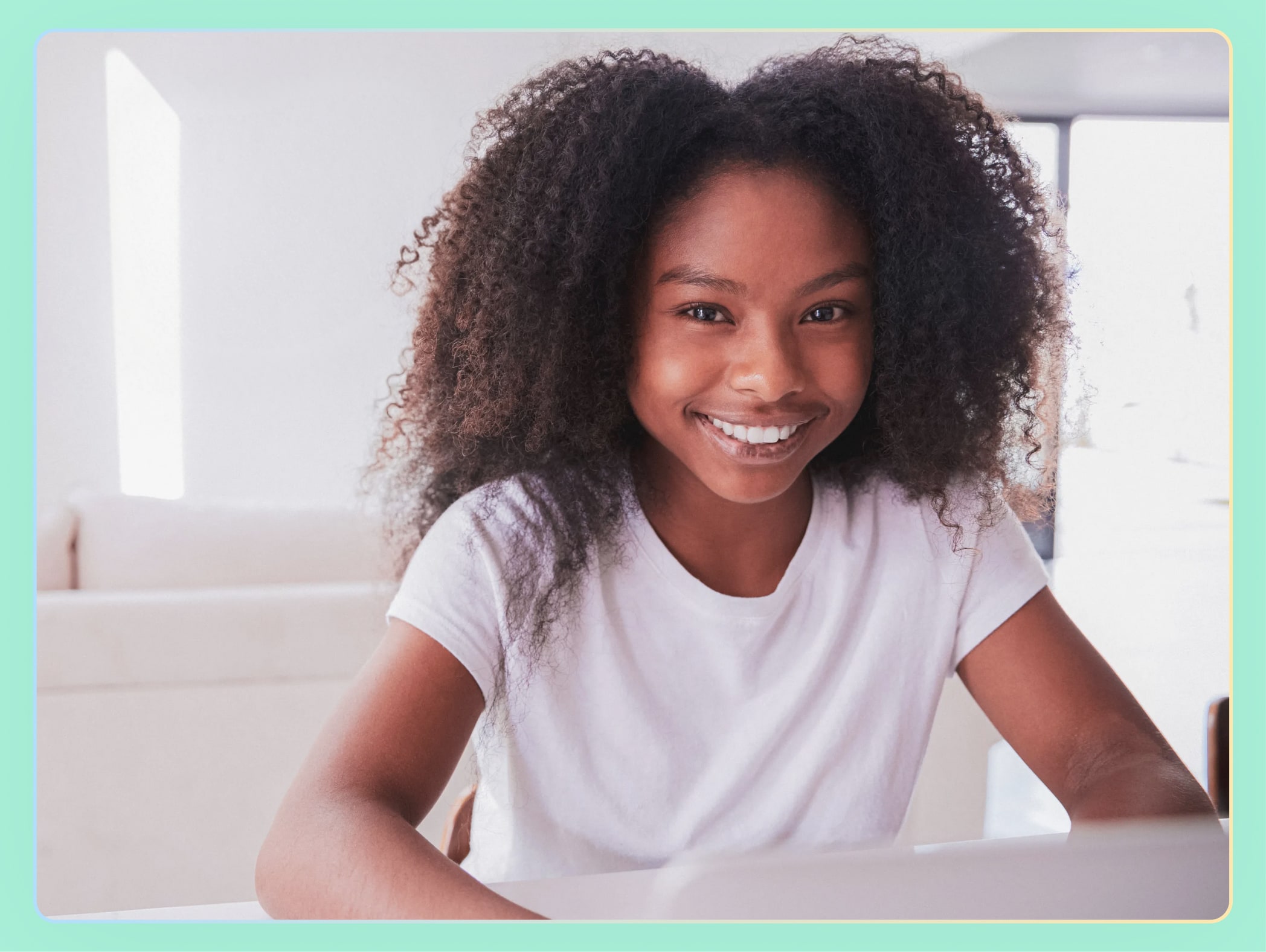 Young African American teen smiling at the camera in a white shirt