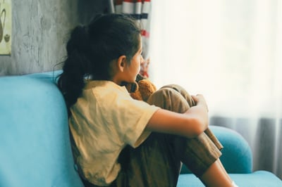 Young girl staring out the window