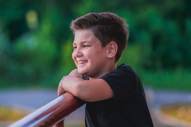 Young boy smiling outside