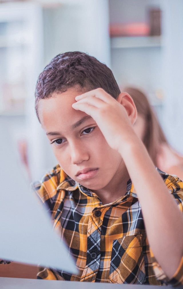 young boy struggling with anxiety at school