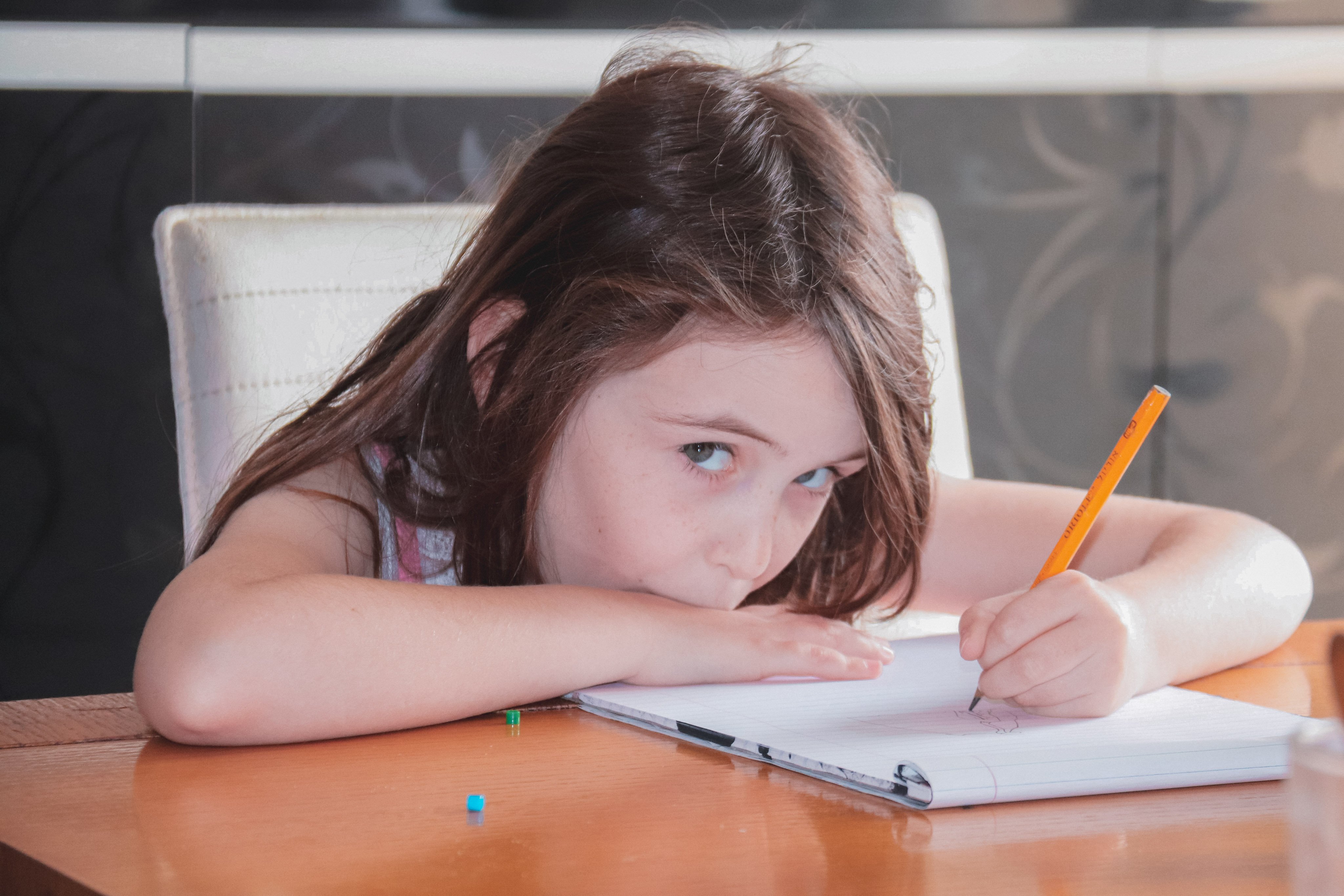 Autistic kid drawing with a pencil