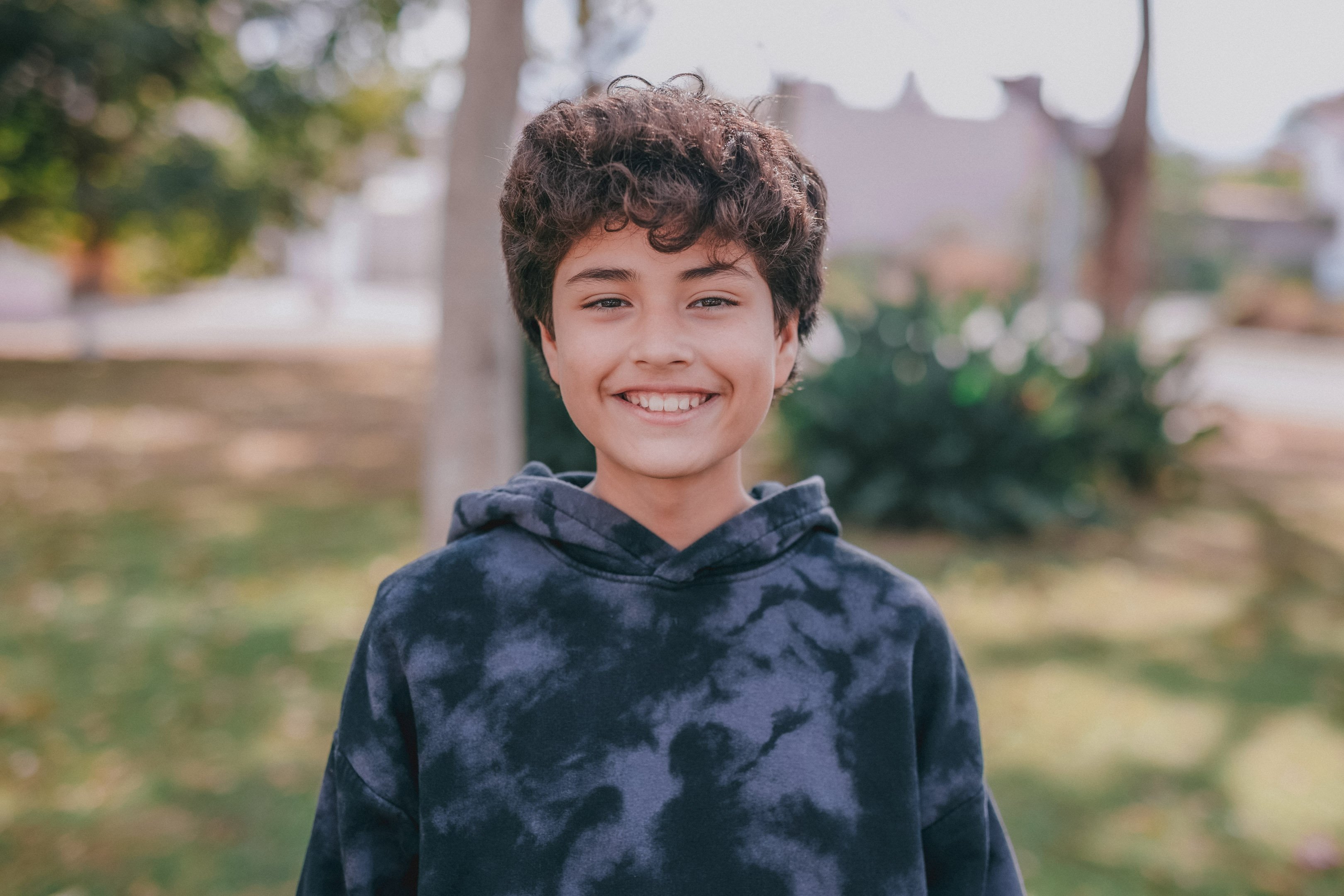 Young boy smiling outside