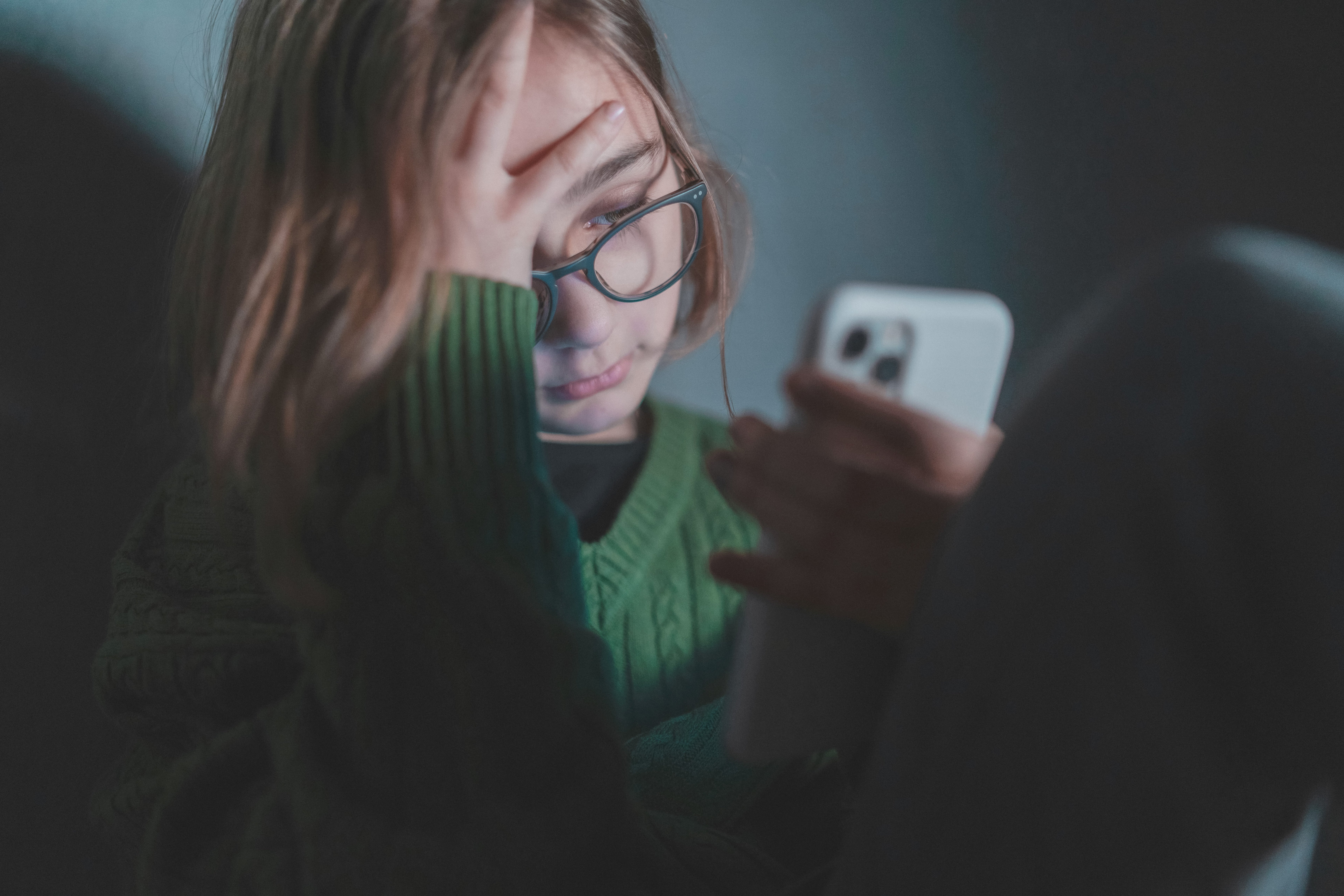 Girl getting cyberbullied looking at her phone