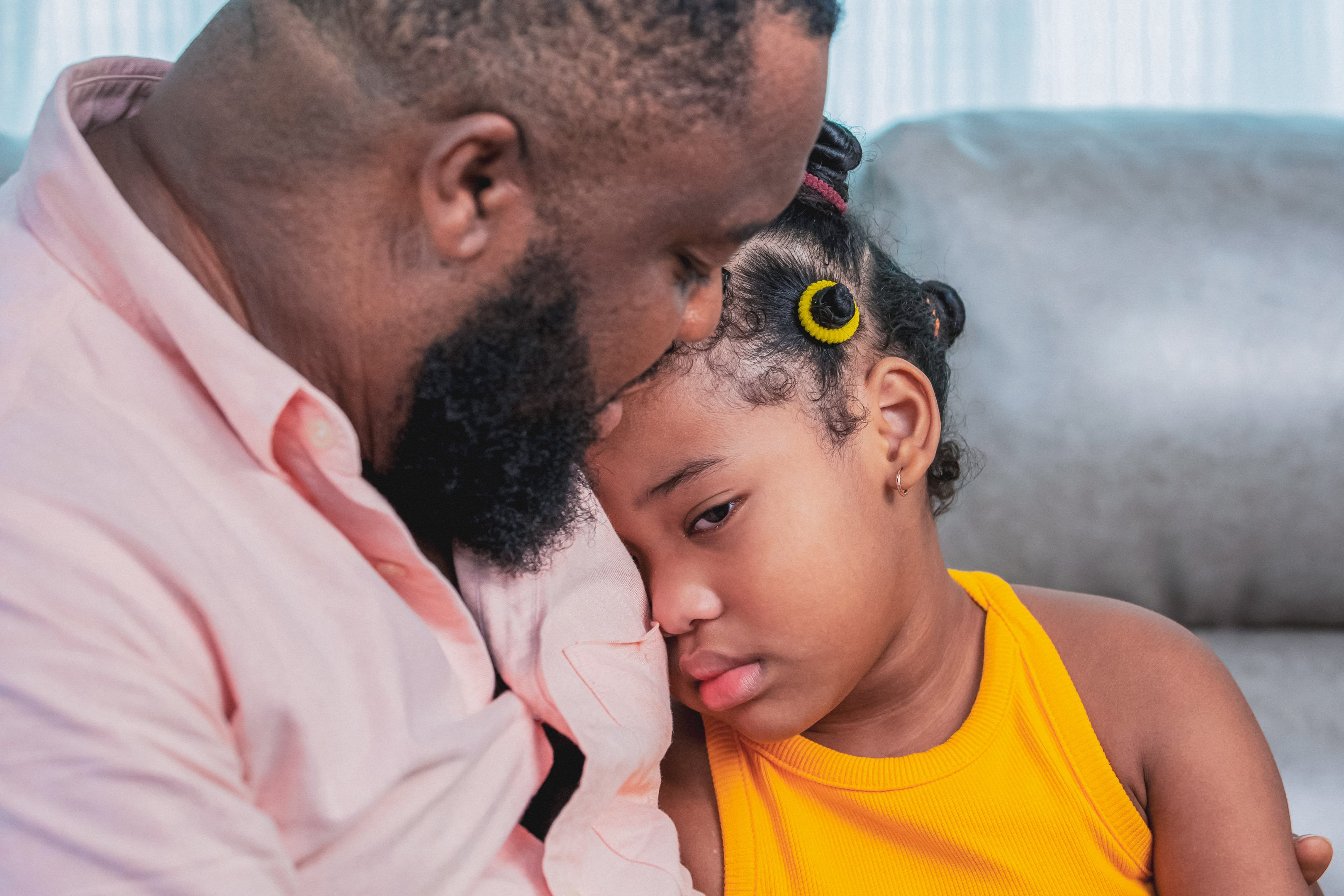 Girl grieving the loss of her pet with her dad