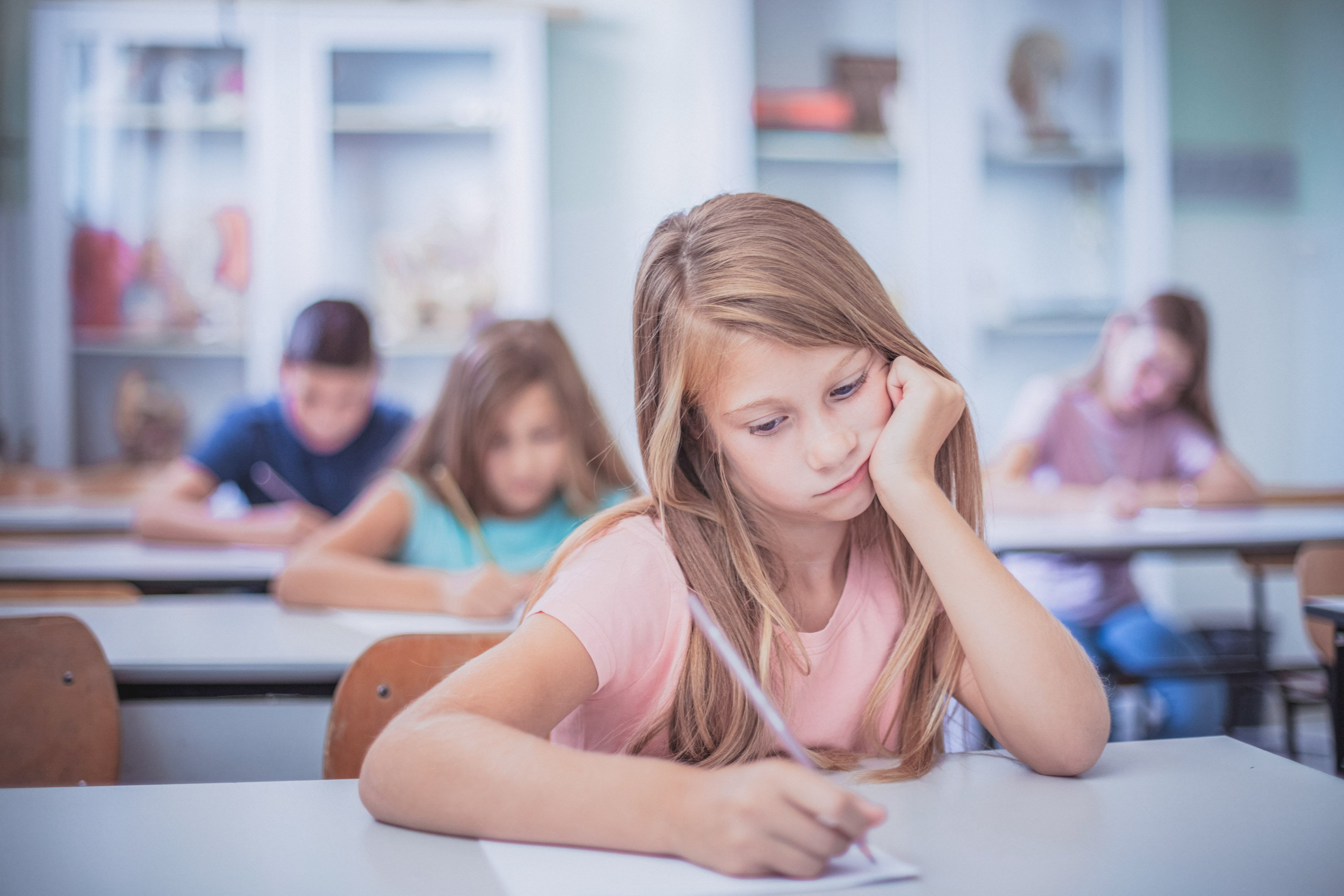 Girl with depression trying to do schoolwork
