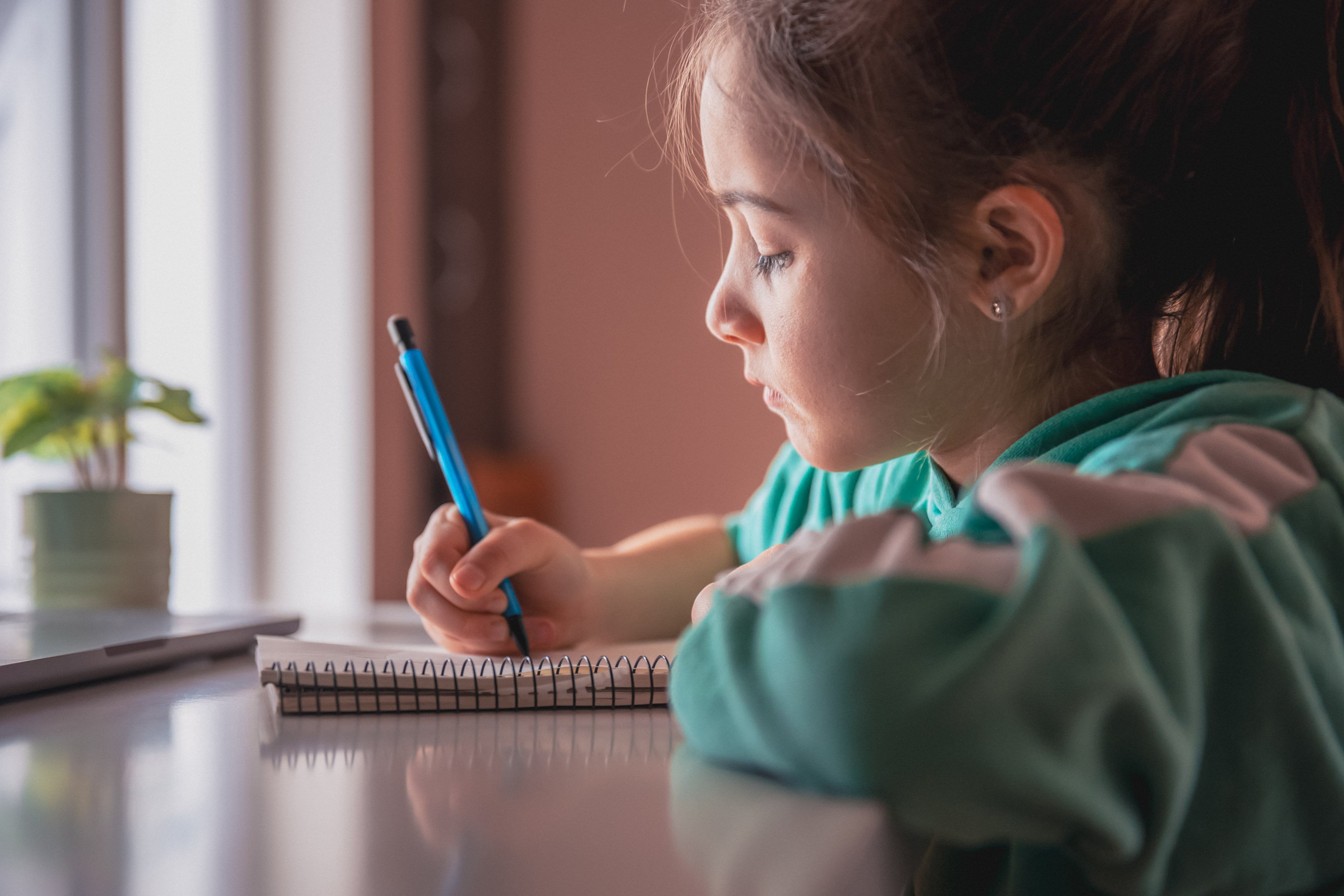 Little girl working on a journaling prompt