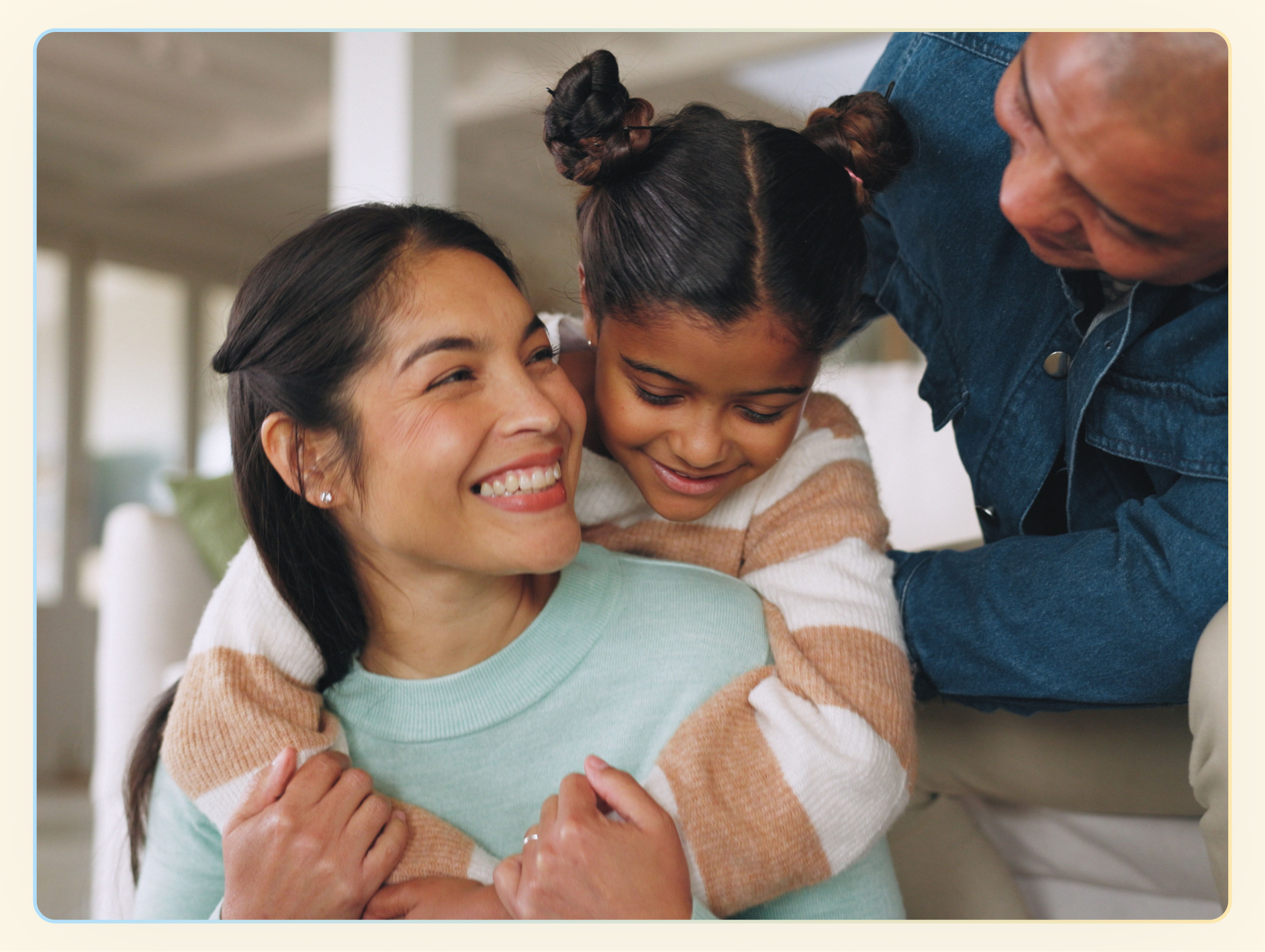 Mom embracing daughter with father at her side