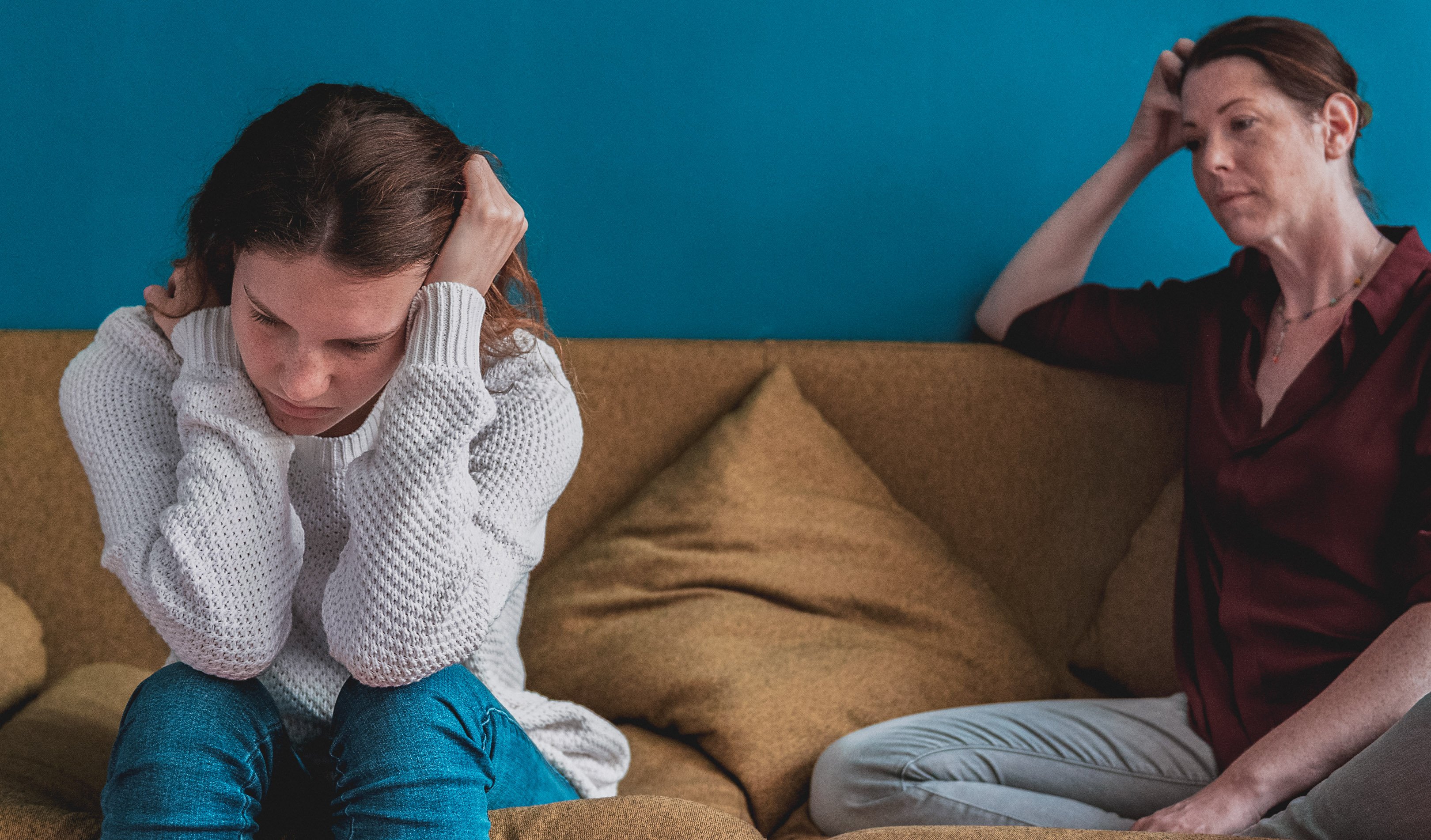 Mom and daughter struggling sitting on couch