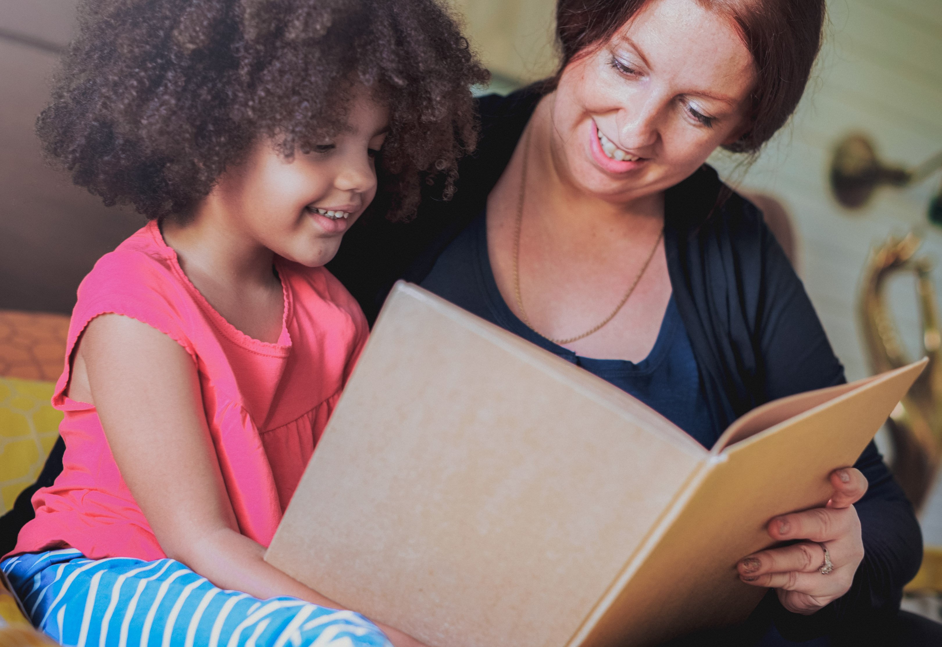 Mom reading a book to her daughter