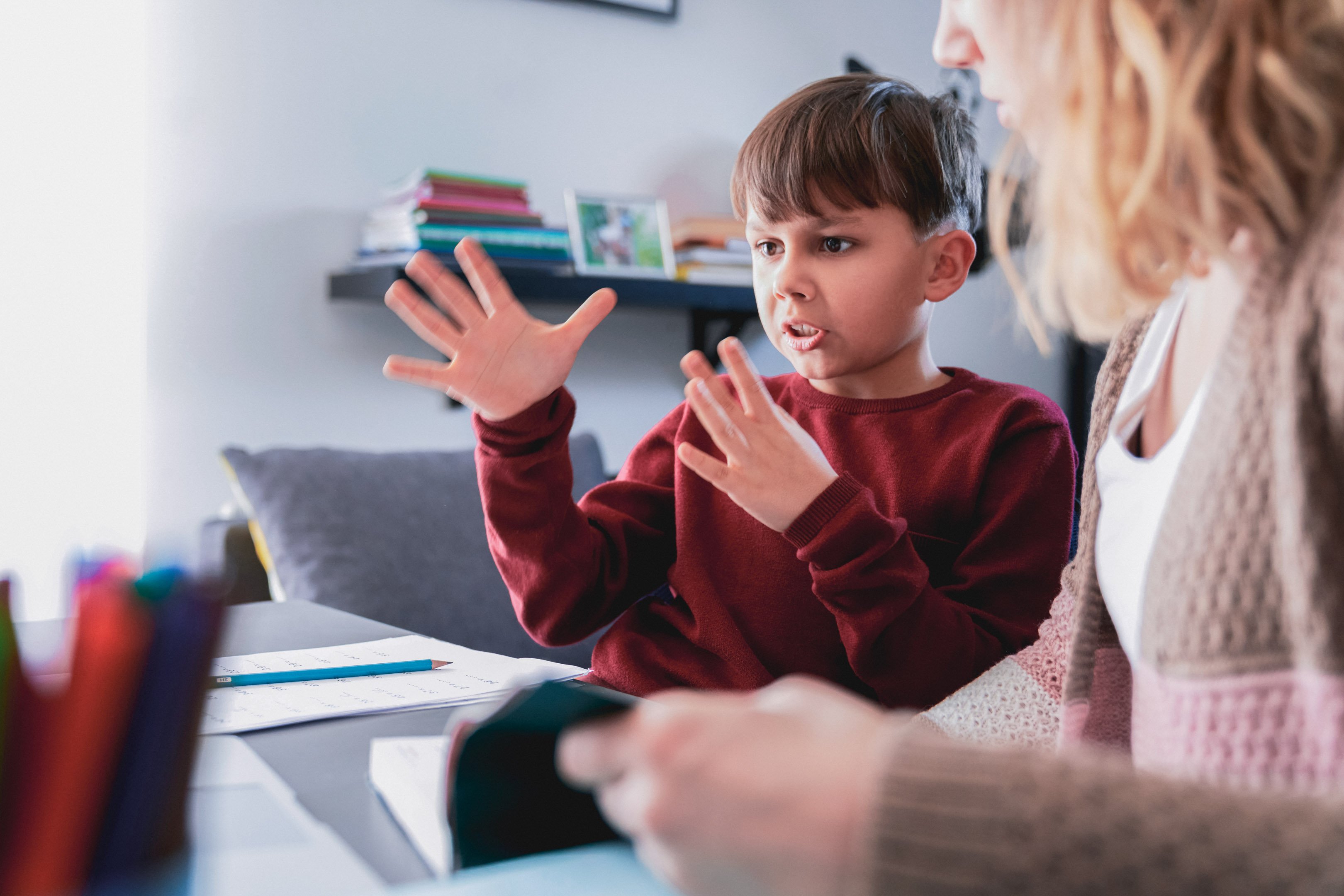 Son and mom reading a book together