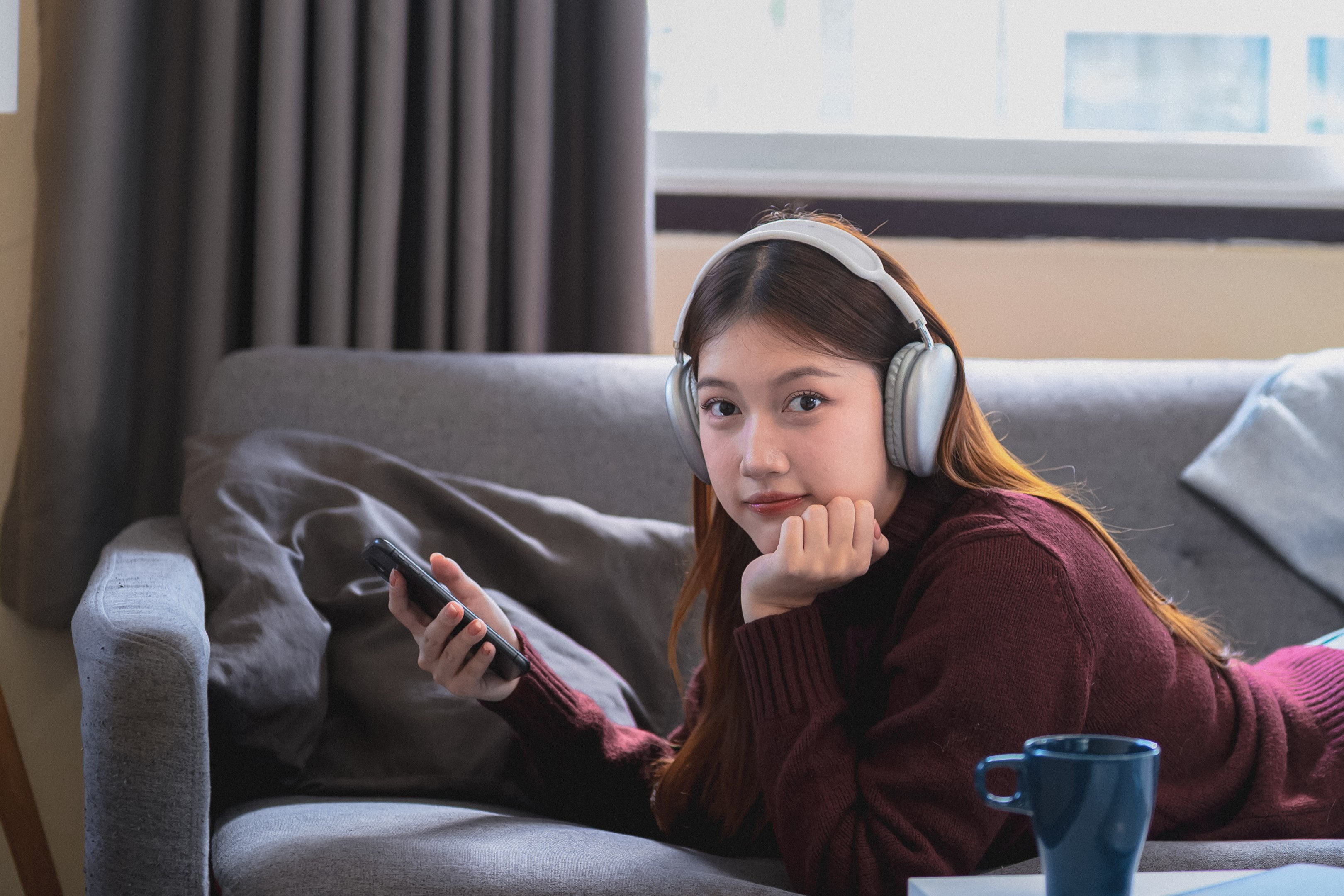 Teen girl listening to music and playing on her phone