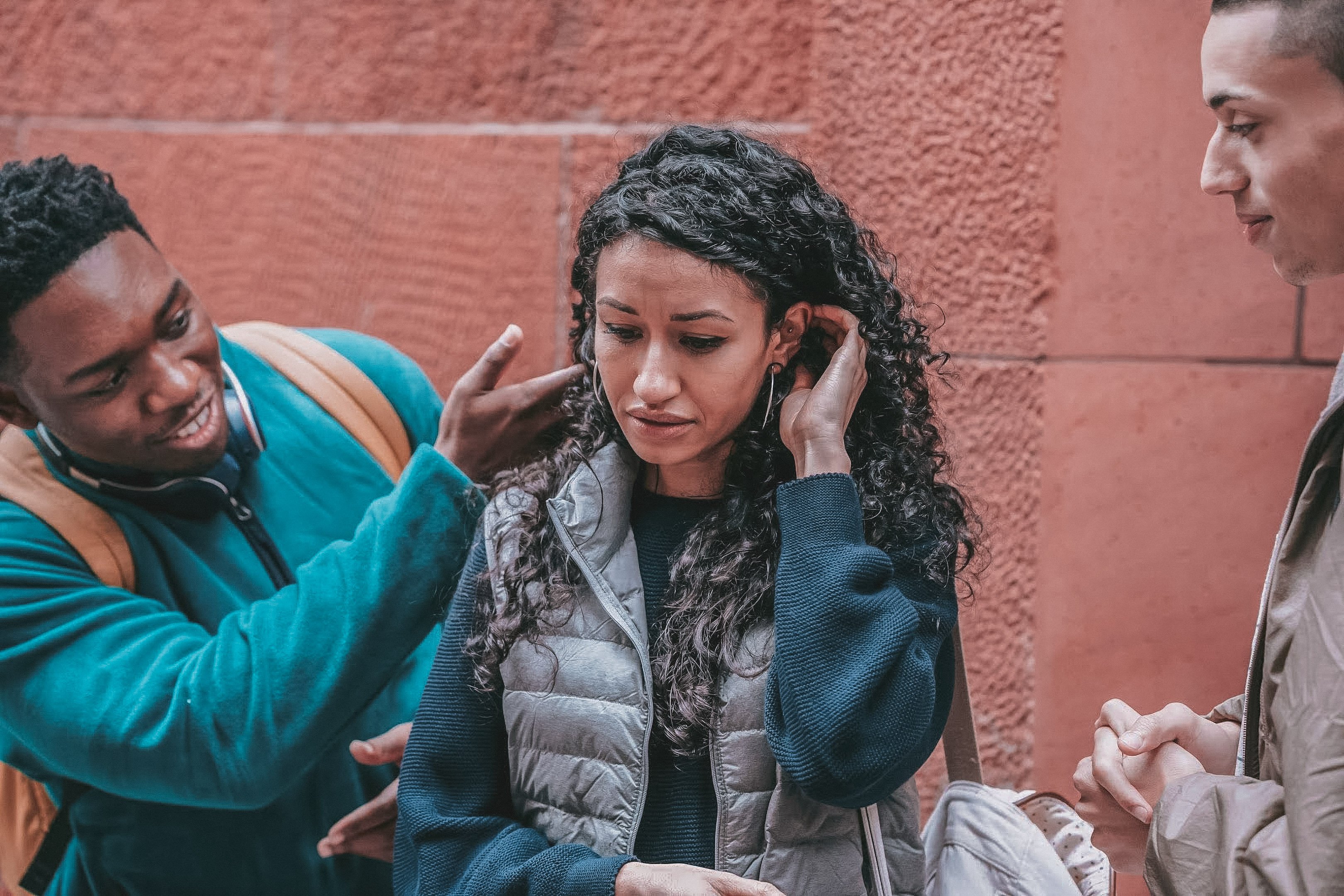 Teen girl struggling with relationship issues with friends comforting her