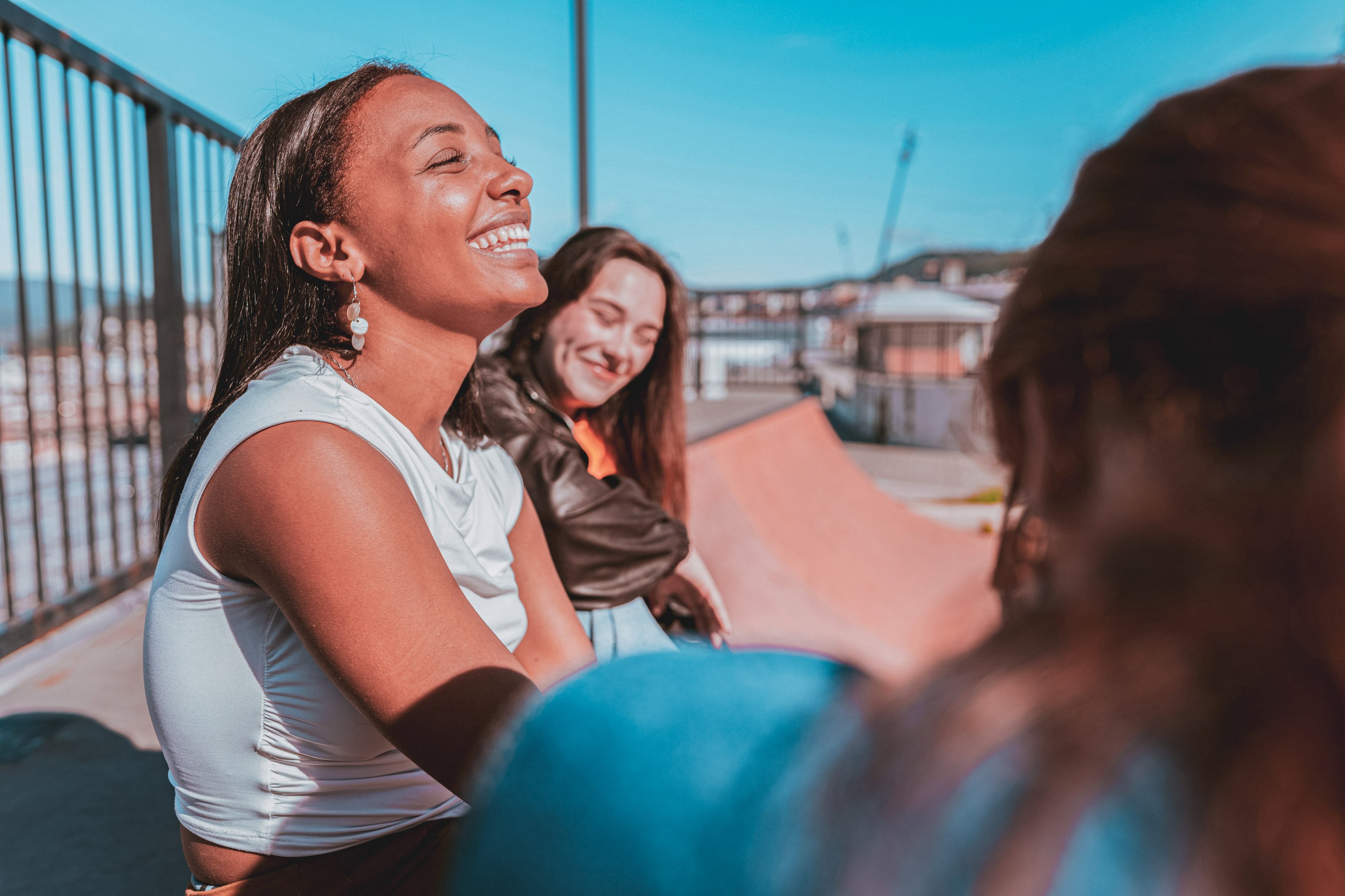 Teen girl laughing at a skatepark