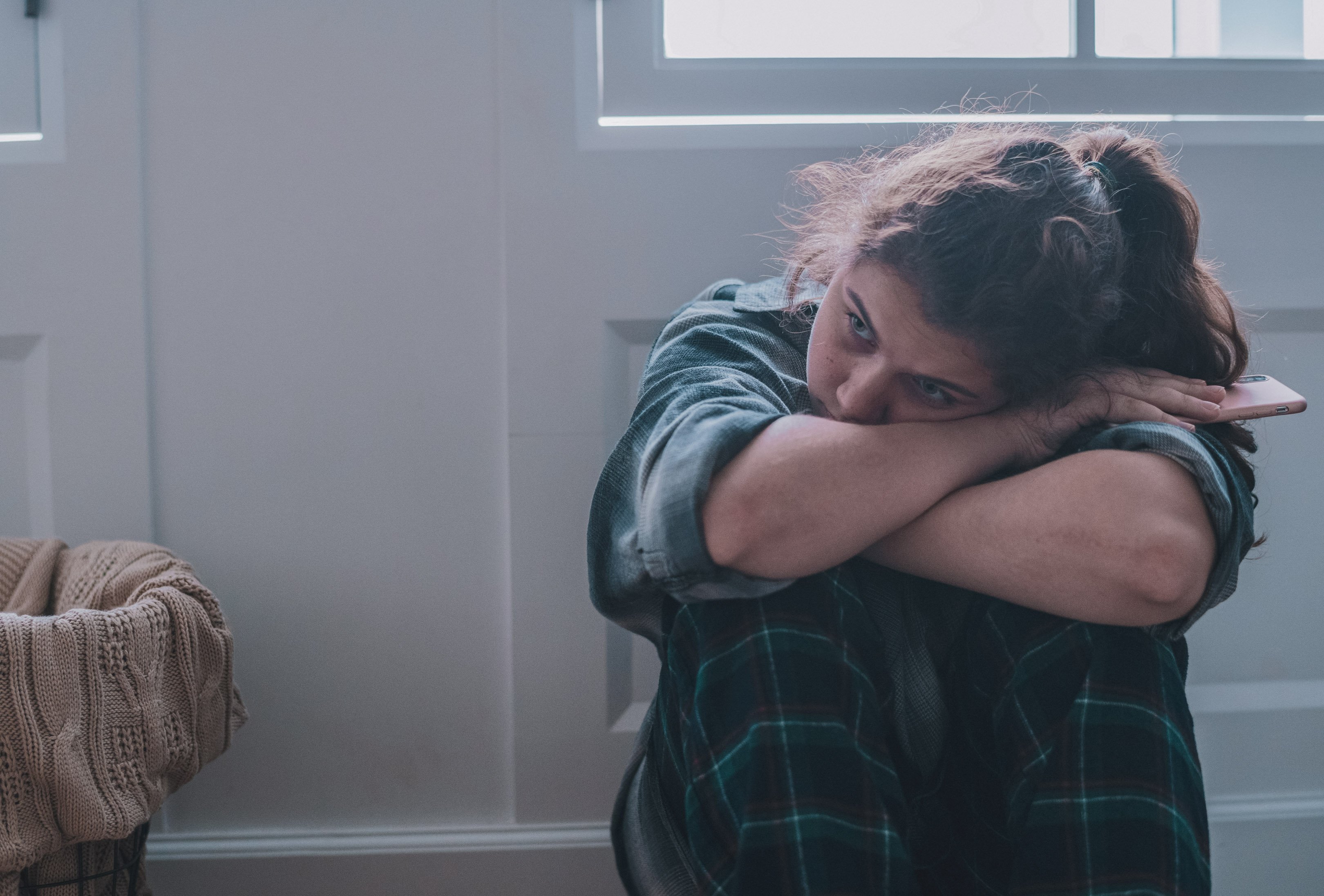Teen sad sitting on the ground dealing with grief