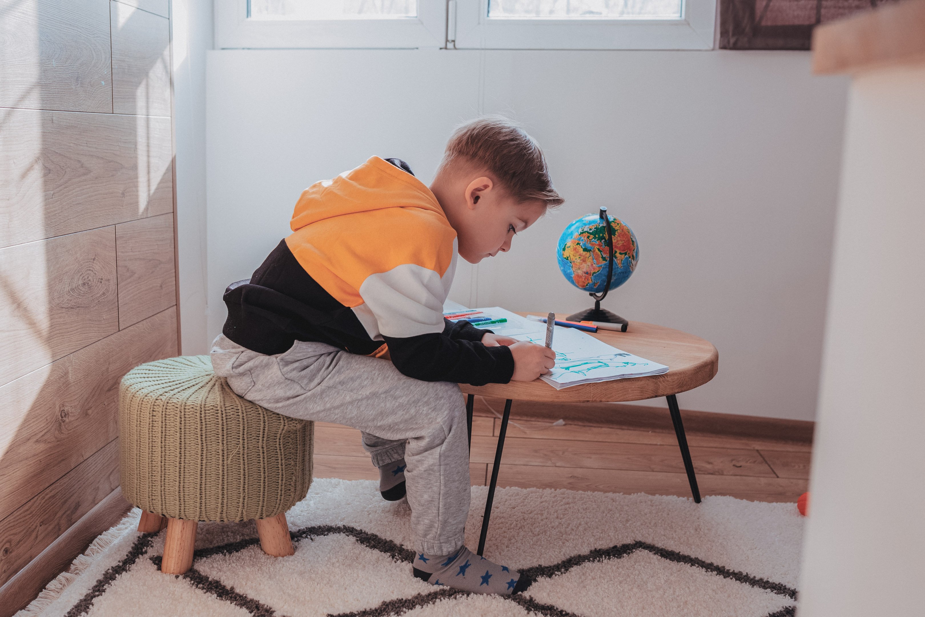 A young boy drawing at home