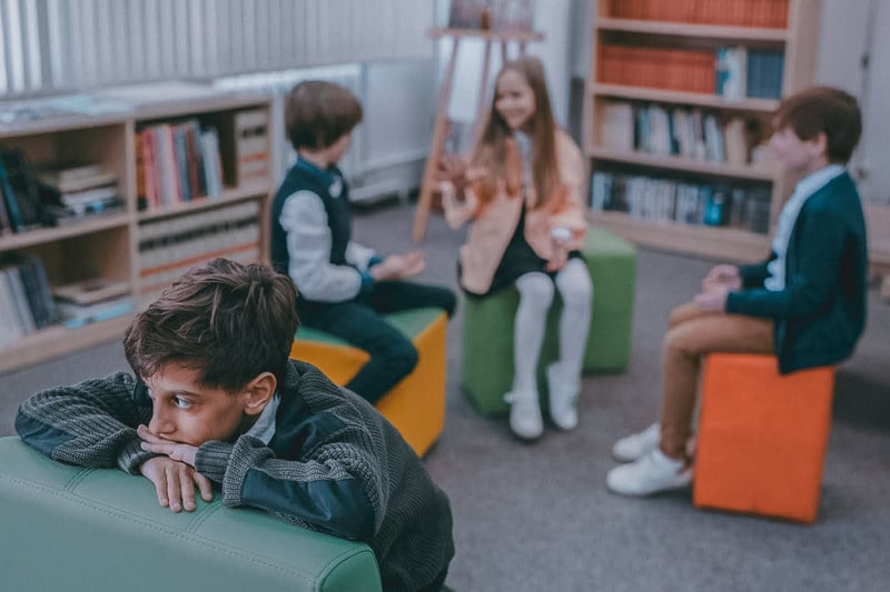 Kid sitting alone in class suffering from PTSD