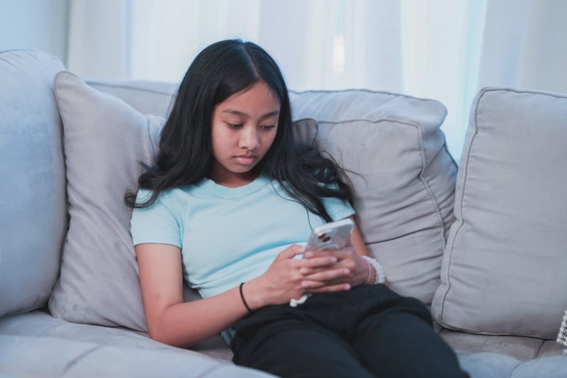 Young girl doom scrolling on her phone