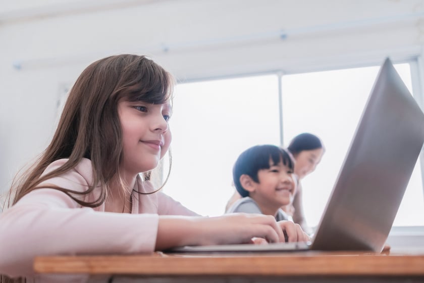 Young girl in the classroom with other students