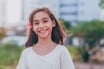 young girl smiling at camera outside