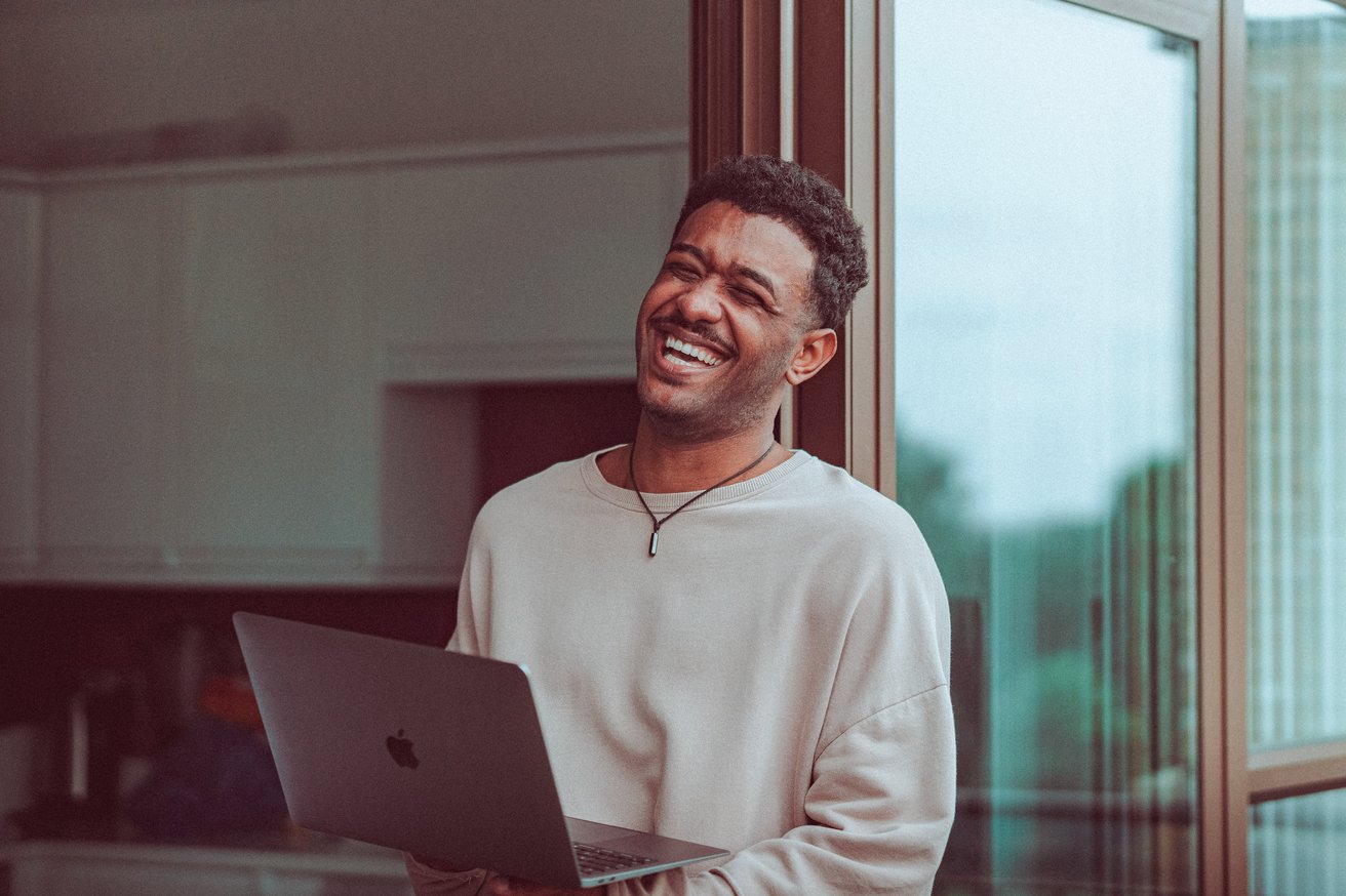 Young adult male laughing