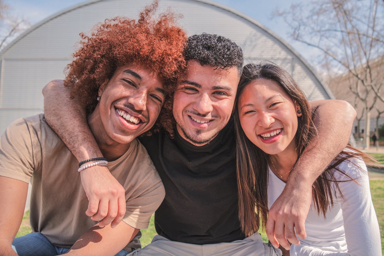 Three young adults, two male and one female, hanging out