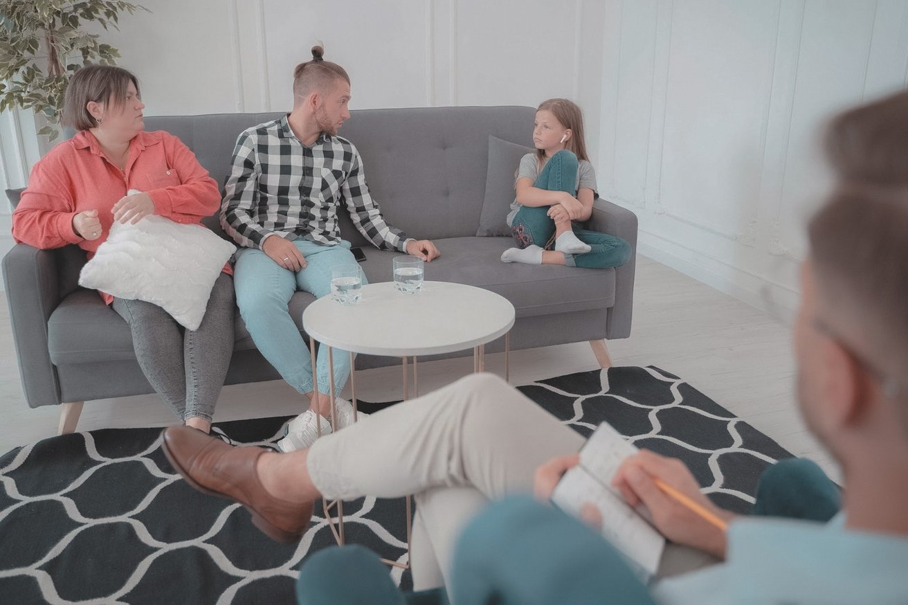 Family on a couch in a family therapy session