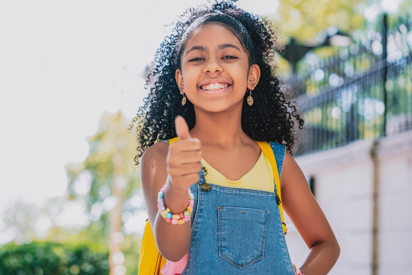 Girl giving a thumb up and smiling