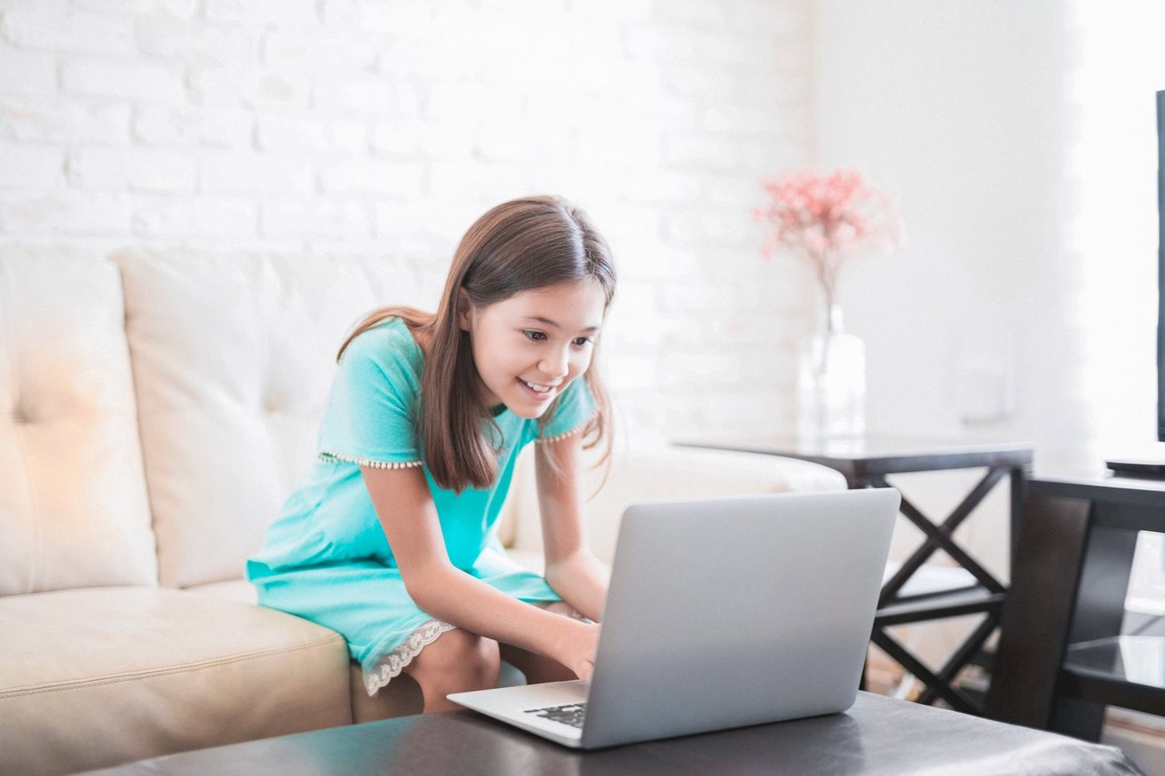 Kid participating in online therapy on the computer