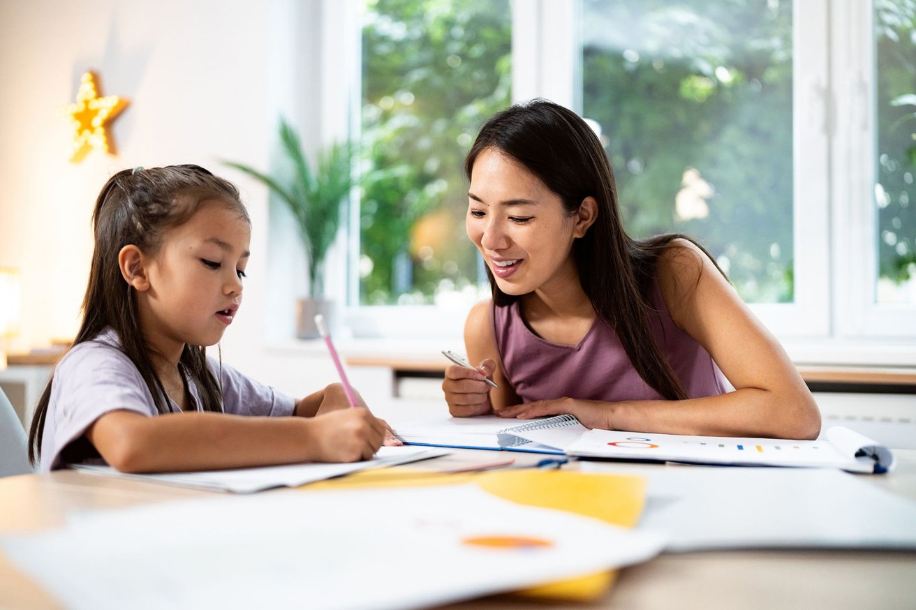 kid studying with teacher