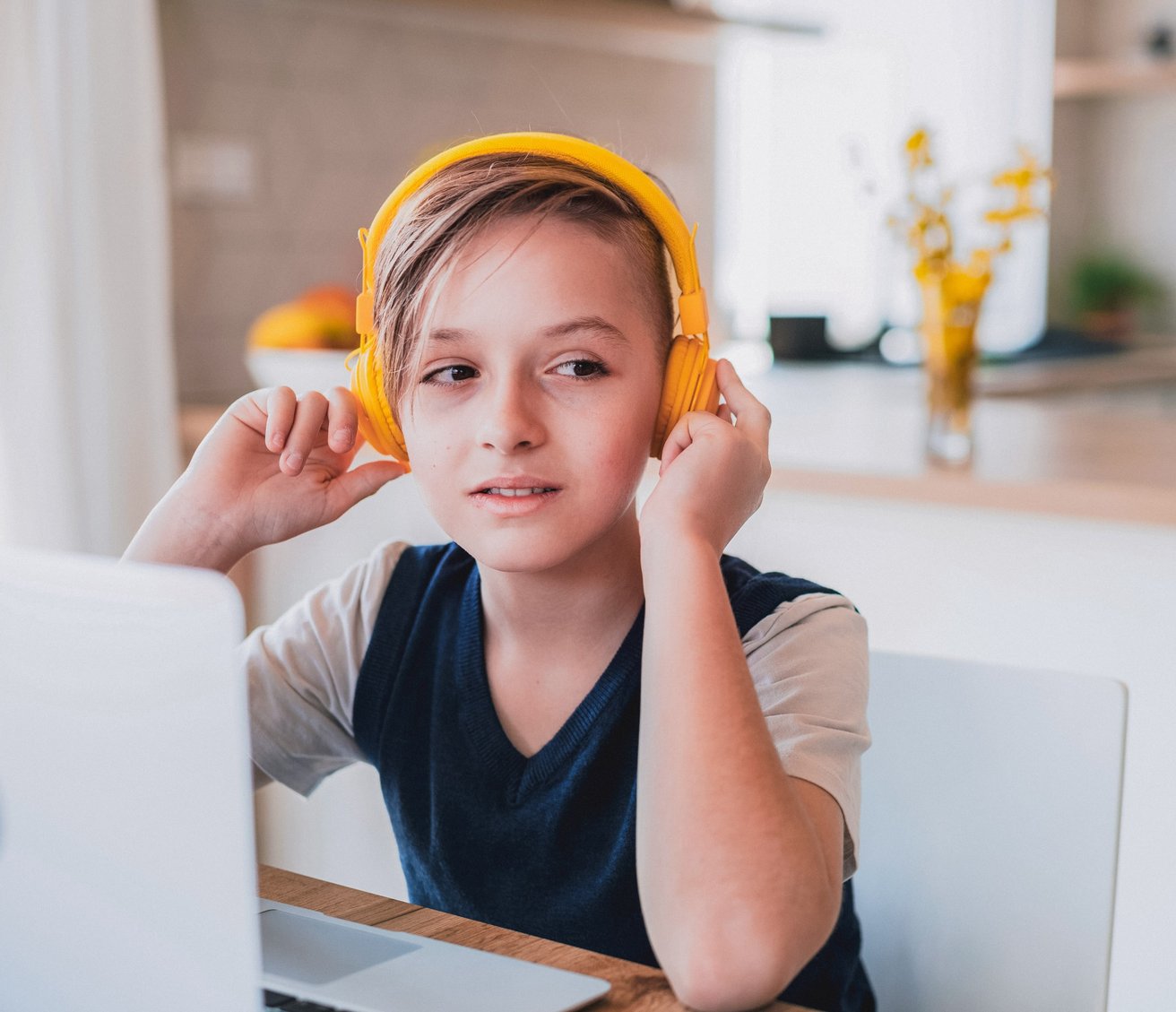 Young boy with yellow headphones on