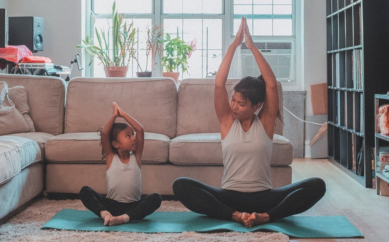 Mom and daughter practicing yoga