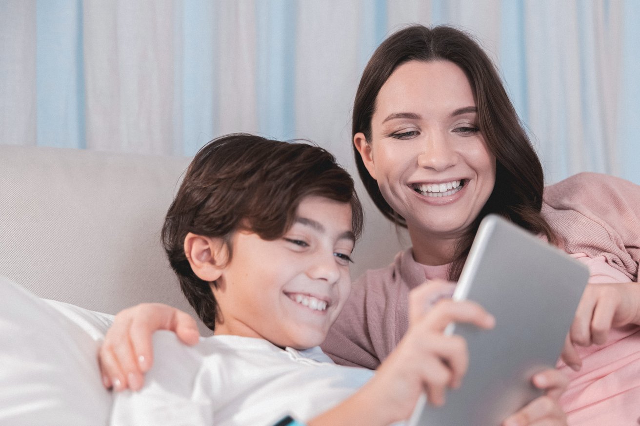 Mom and son reviewing something on a tablet