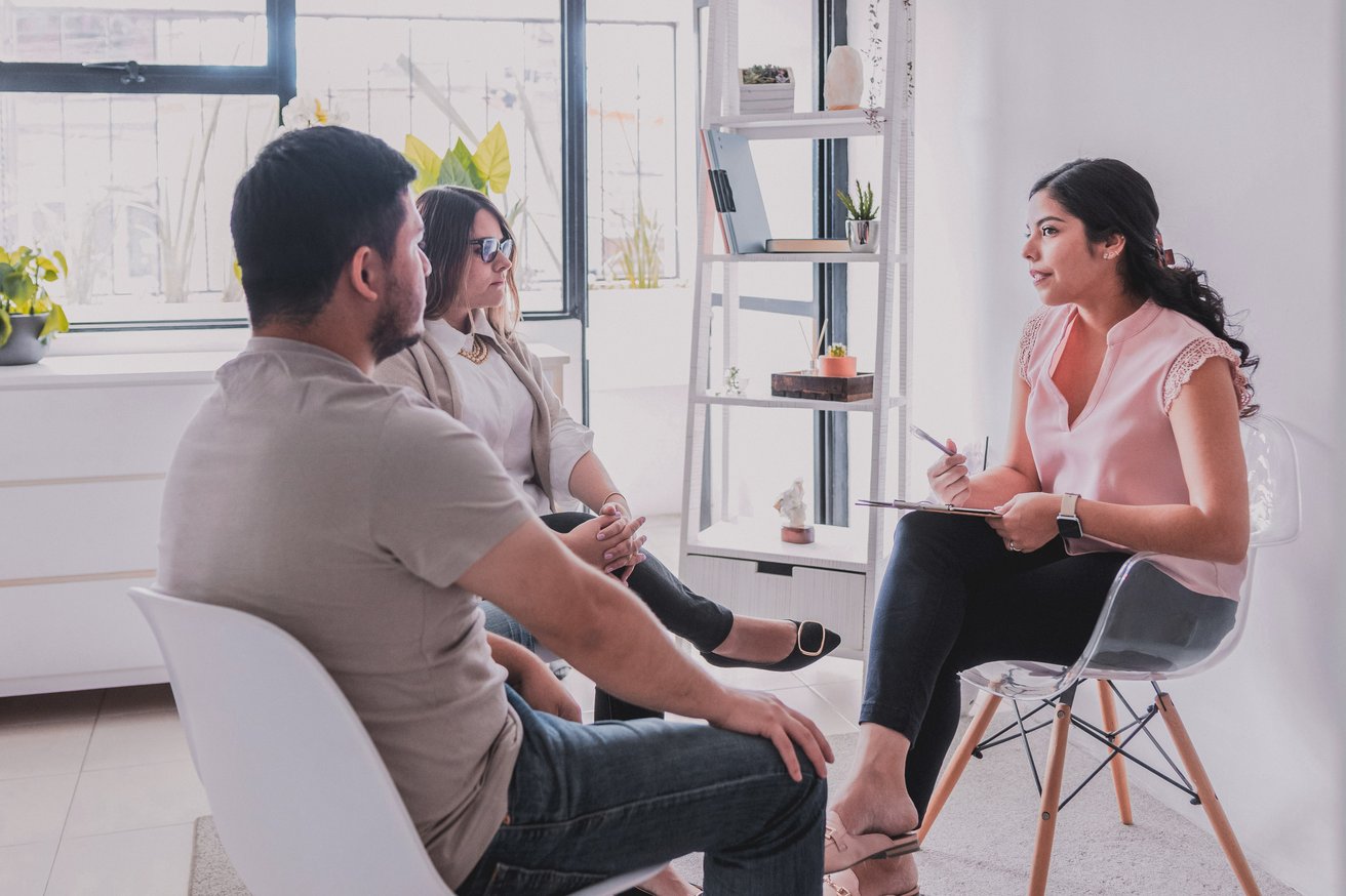 Parents talking to their child's therapist