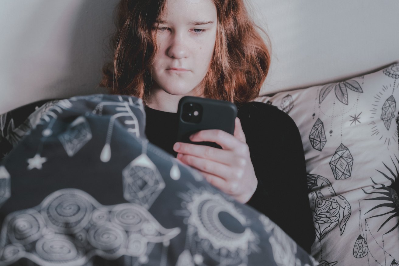 Teen girl looking at social media on phone