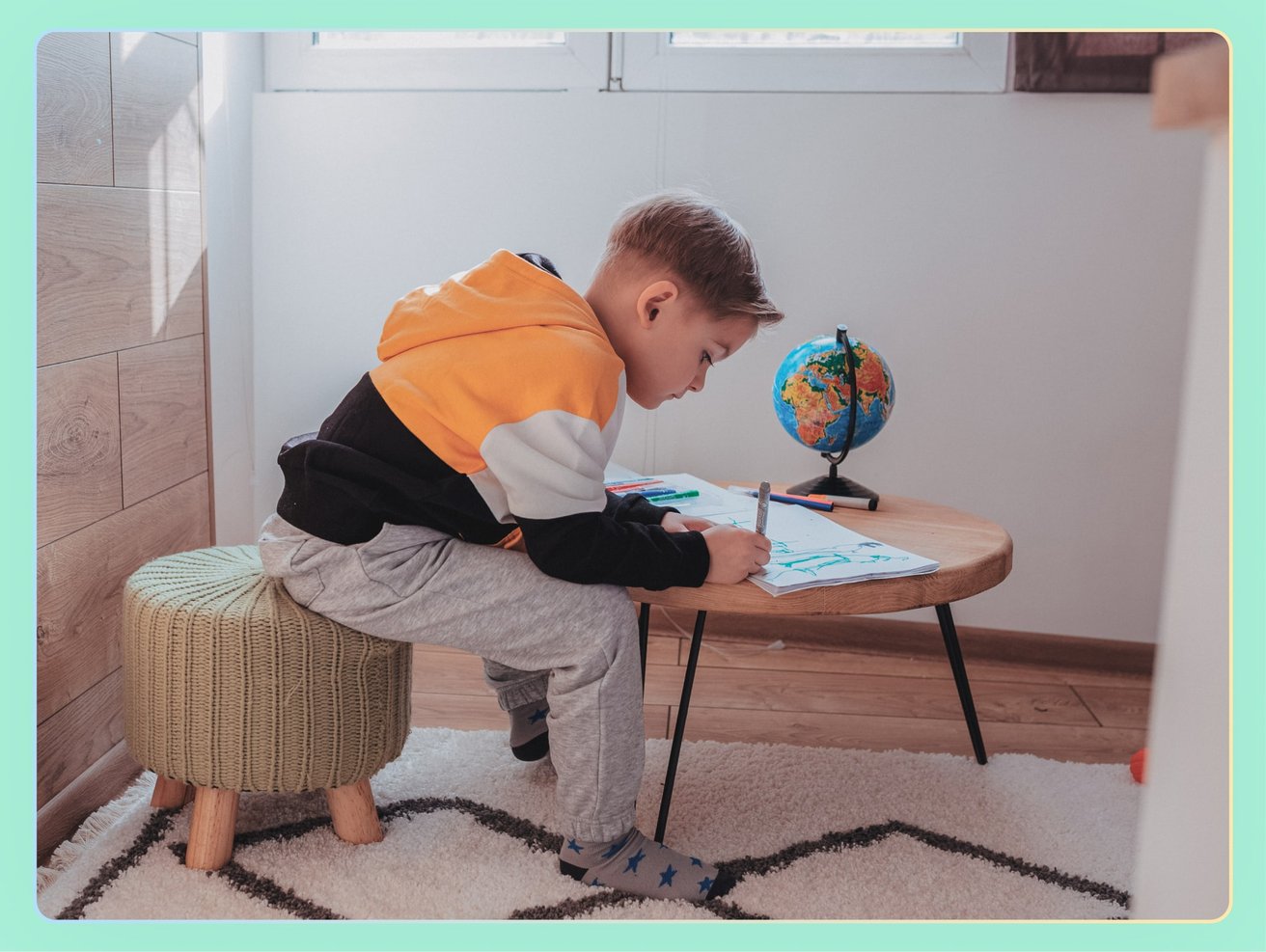 young boy drawing at home
