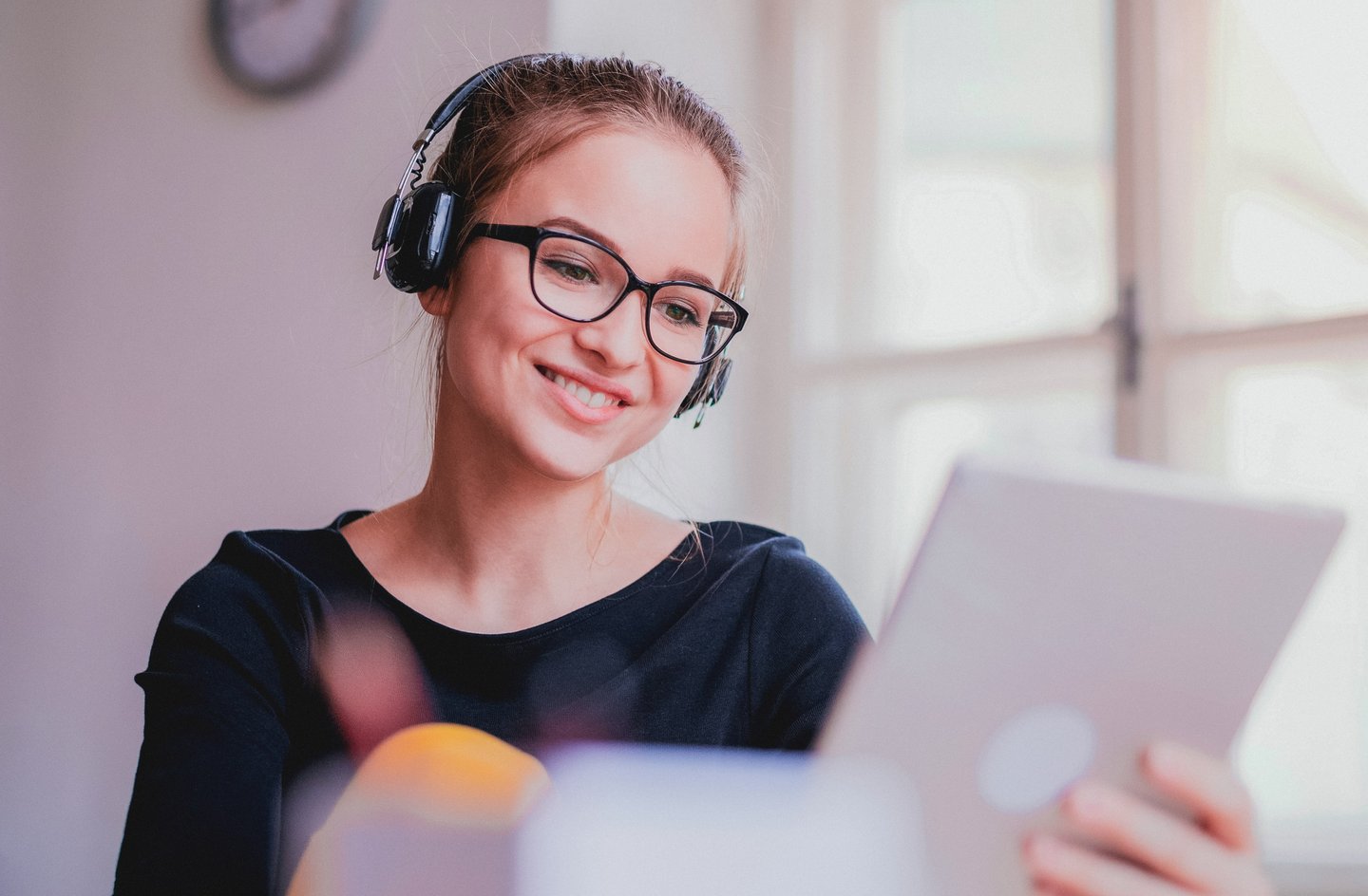 Young girl with headphones on our tablet
