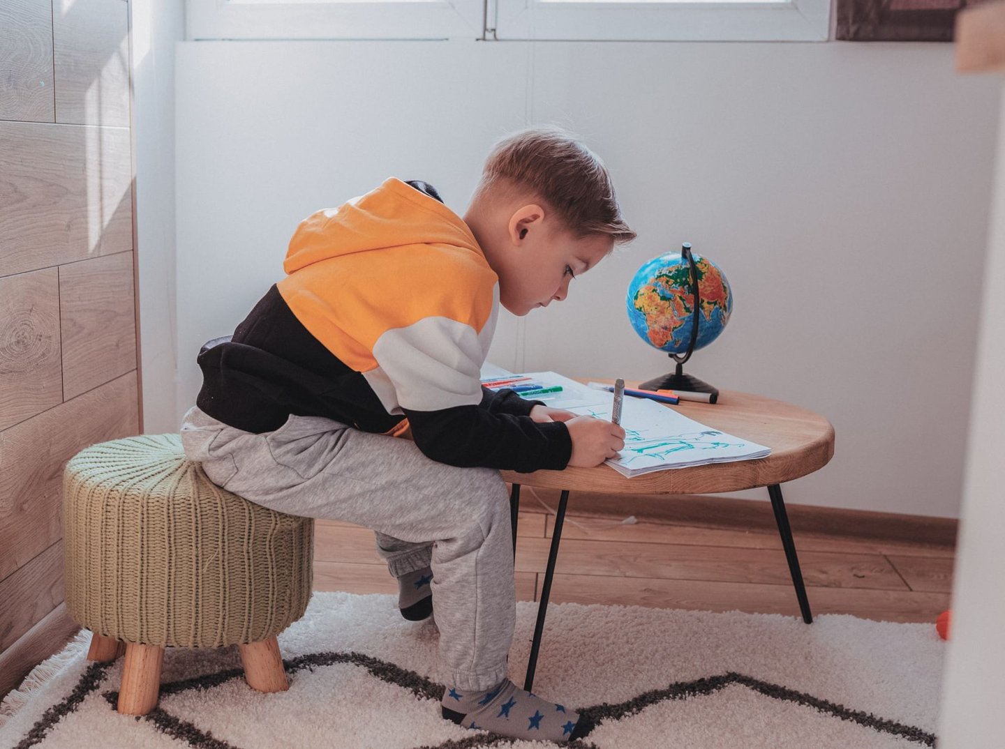 A young boy drawing at home