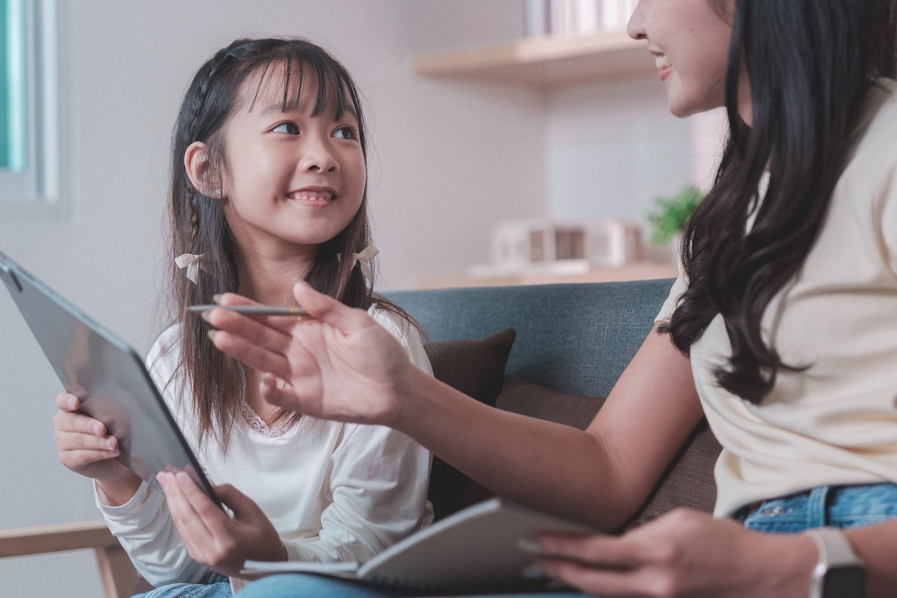 Child doing online therapy with mom