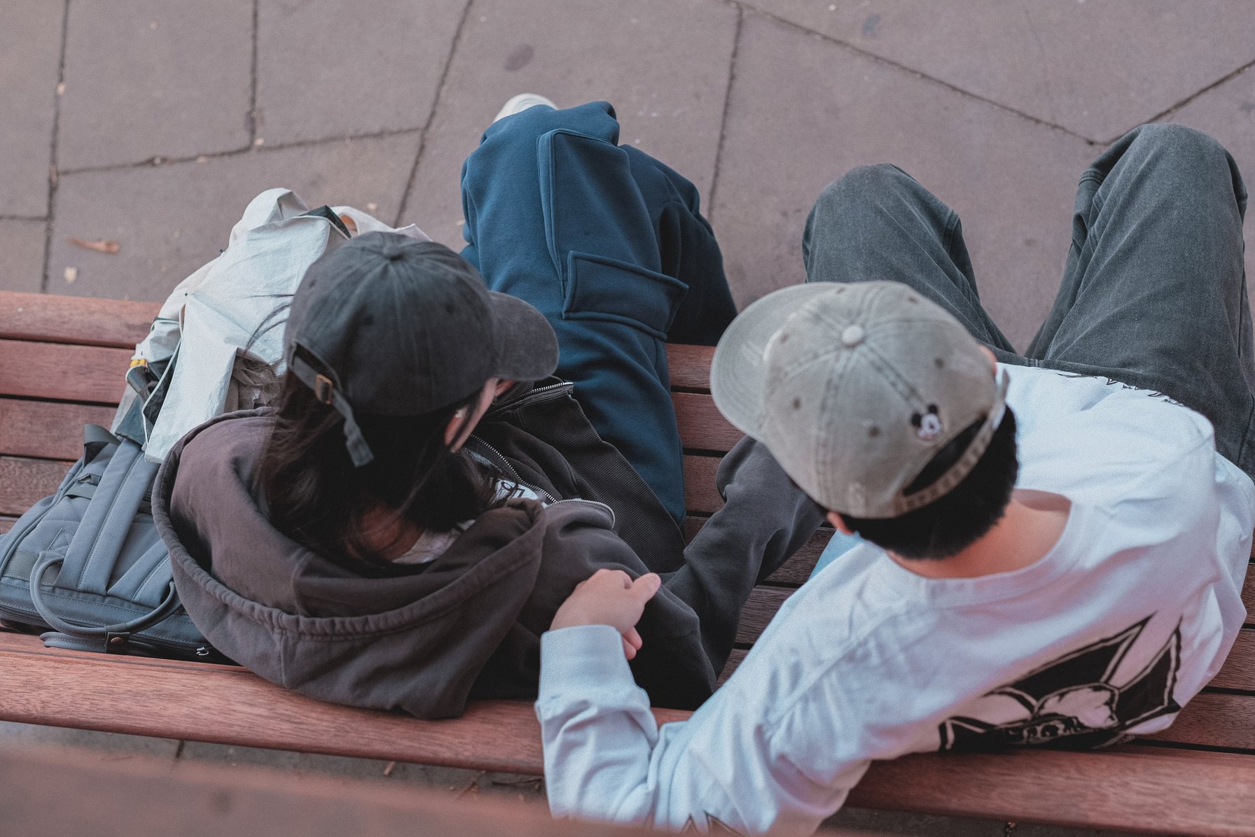 Teen couple talking on a bench