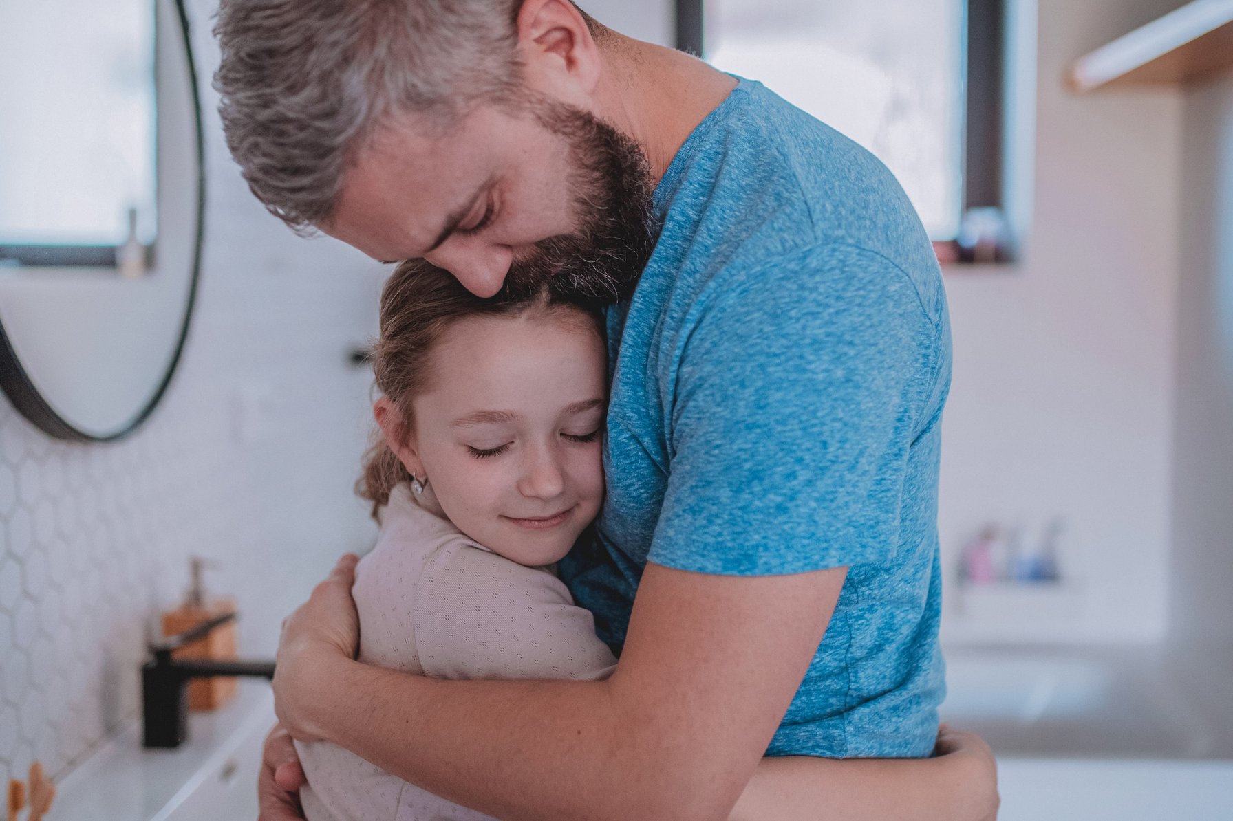 Father comforting his daughter who is grieving