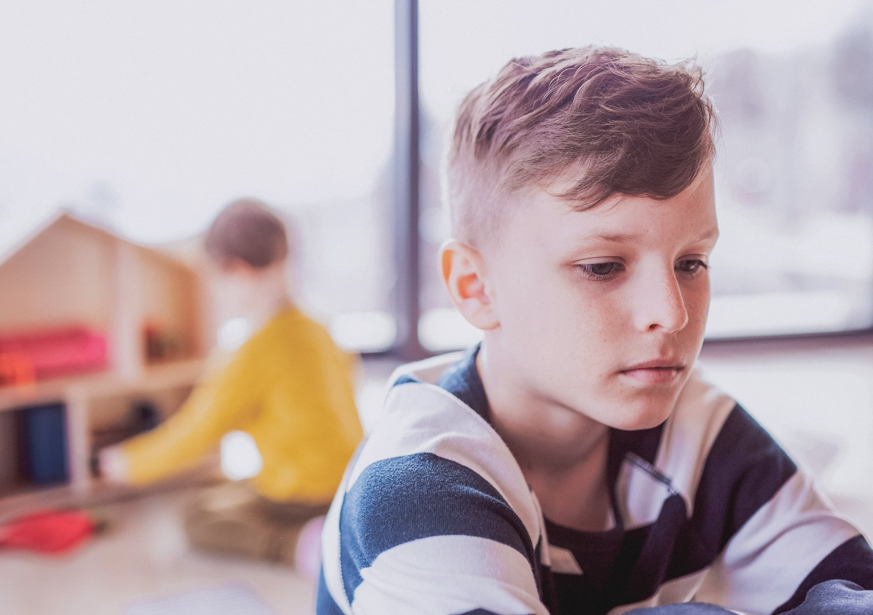 Kid dealing with trauma sitting alone