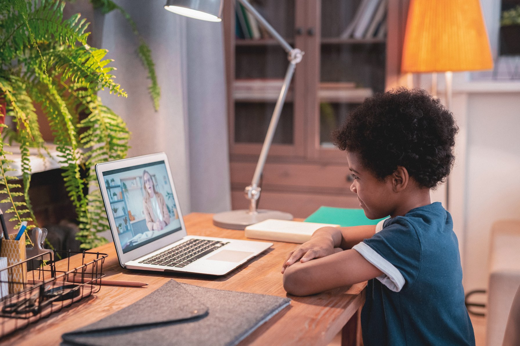 Kid doing online therapy on a laptop