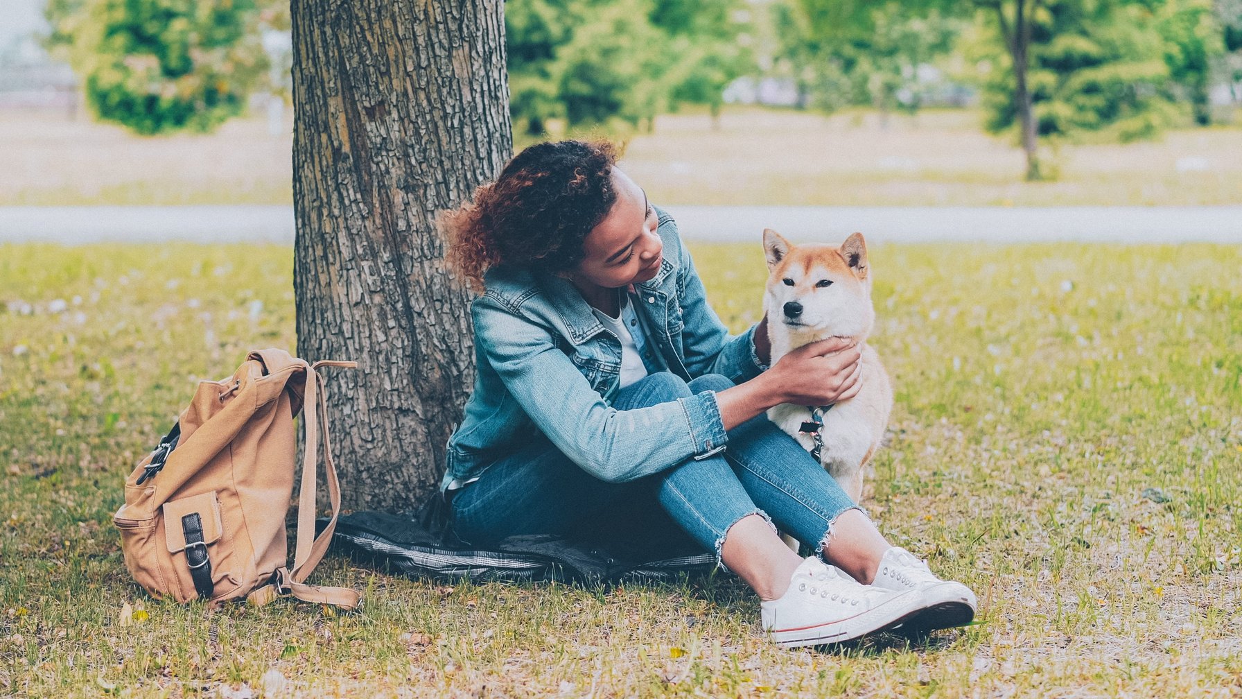 Kid playing with a dog in the park