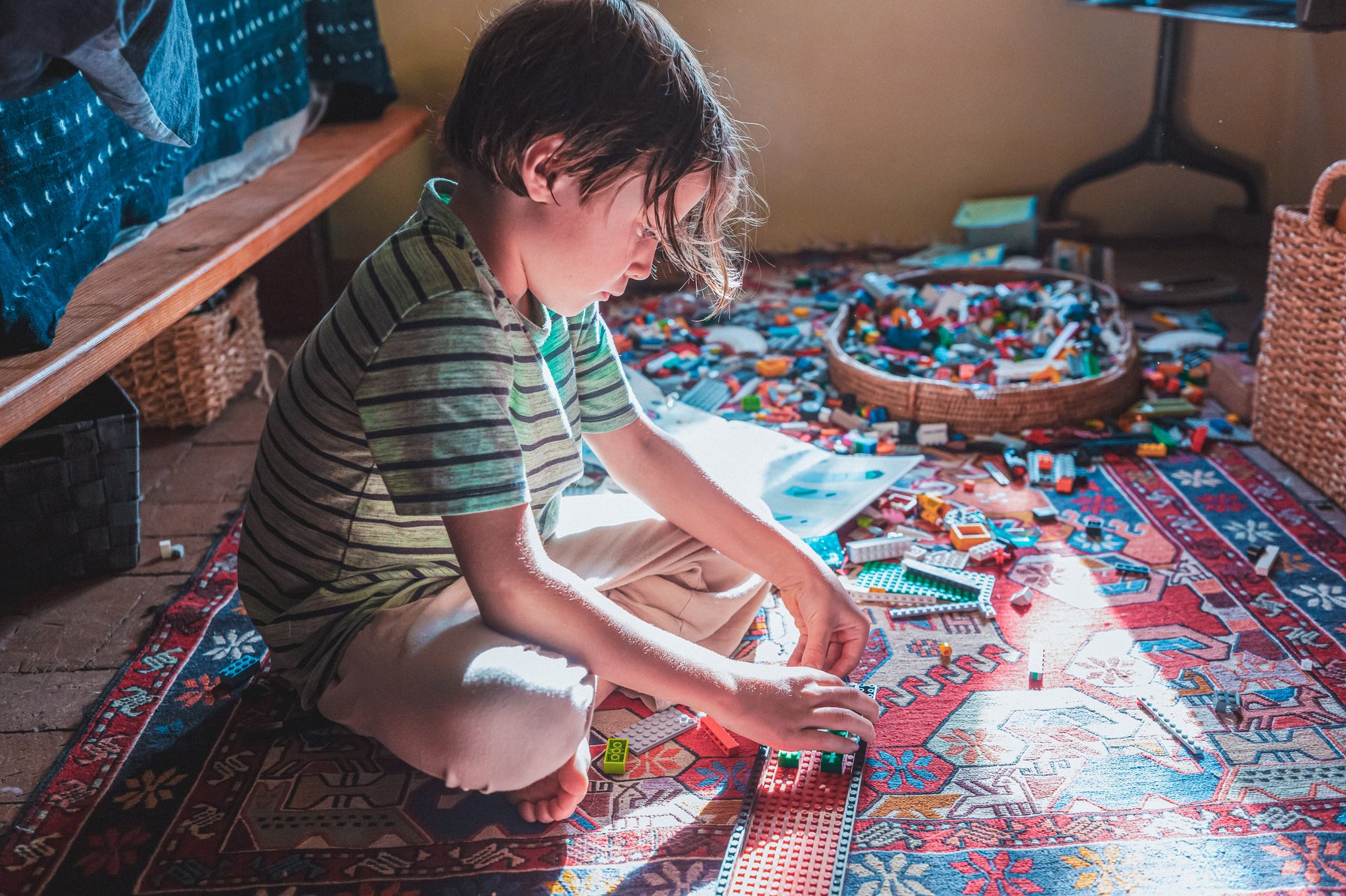 Kid with ADHD playing with toys in a messy room