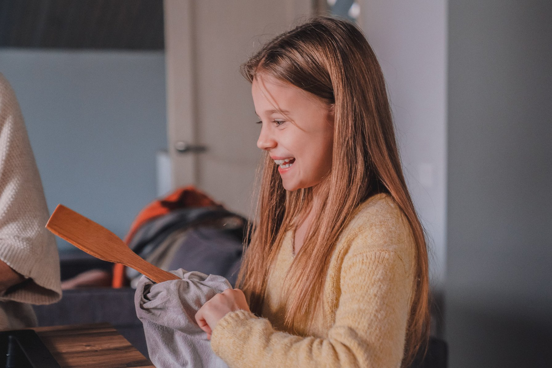 Little girl helping her parents with cooking