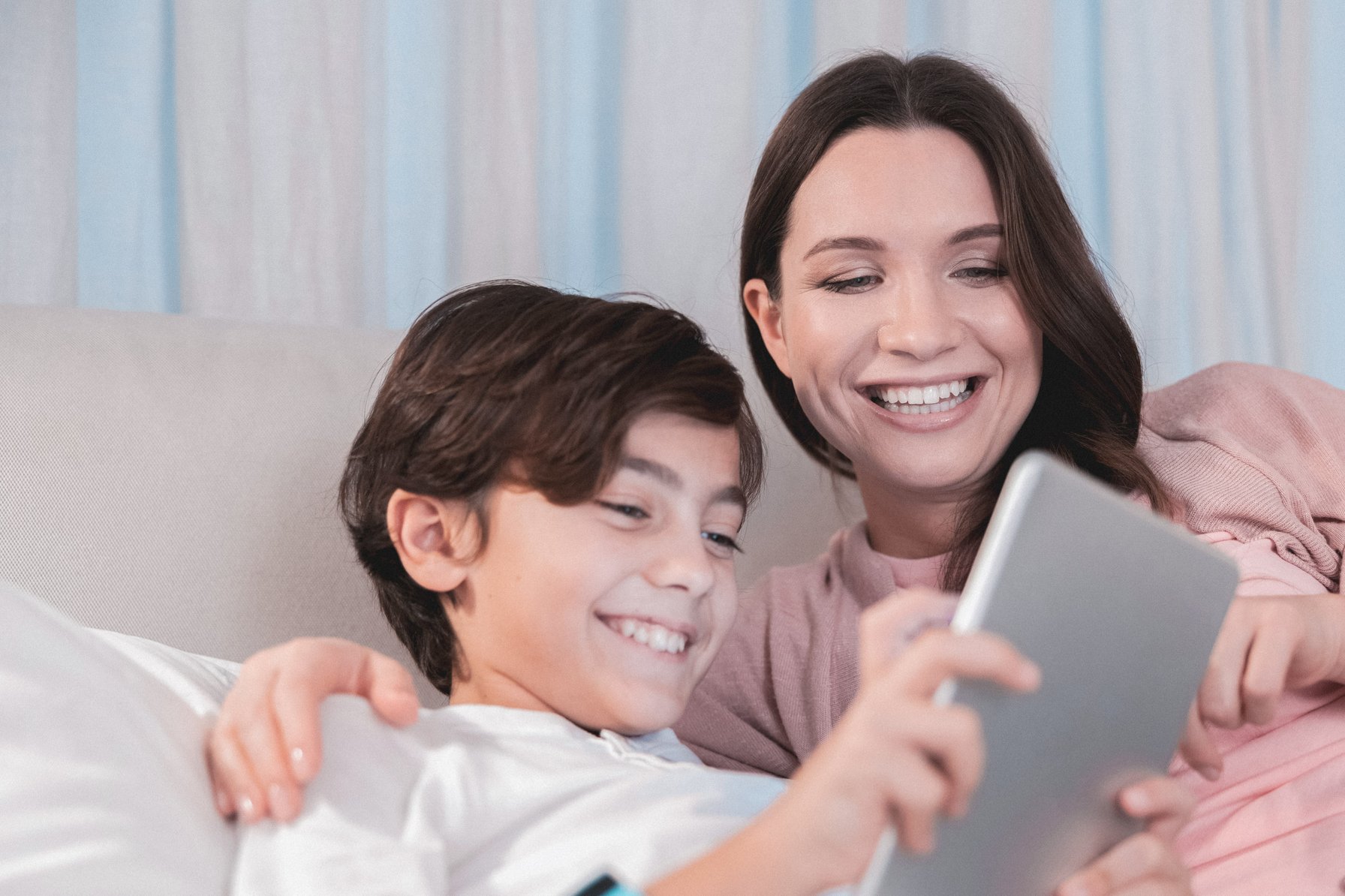 Mom and son reviewing something on a tablet
