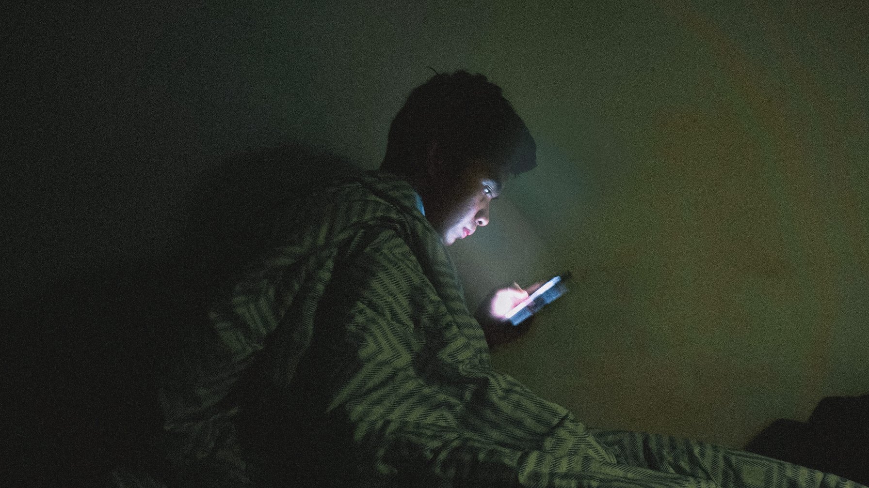 Stressed kid scrolling through his phone