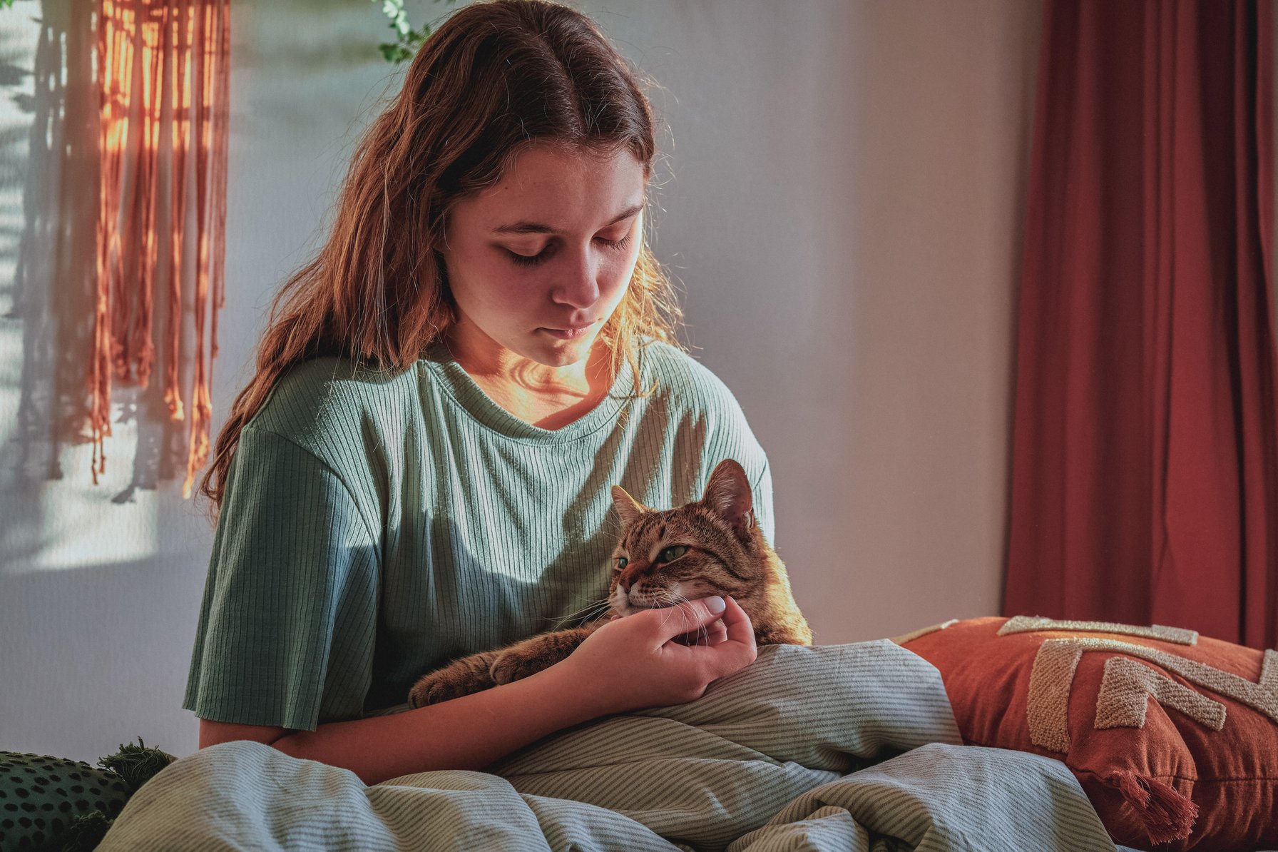 Teen girl petting her cat