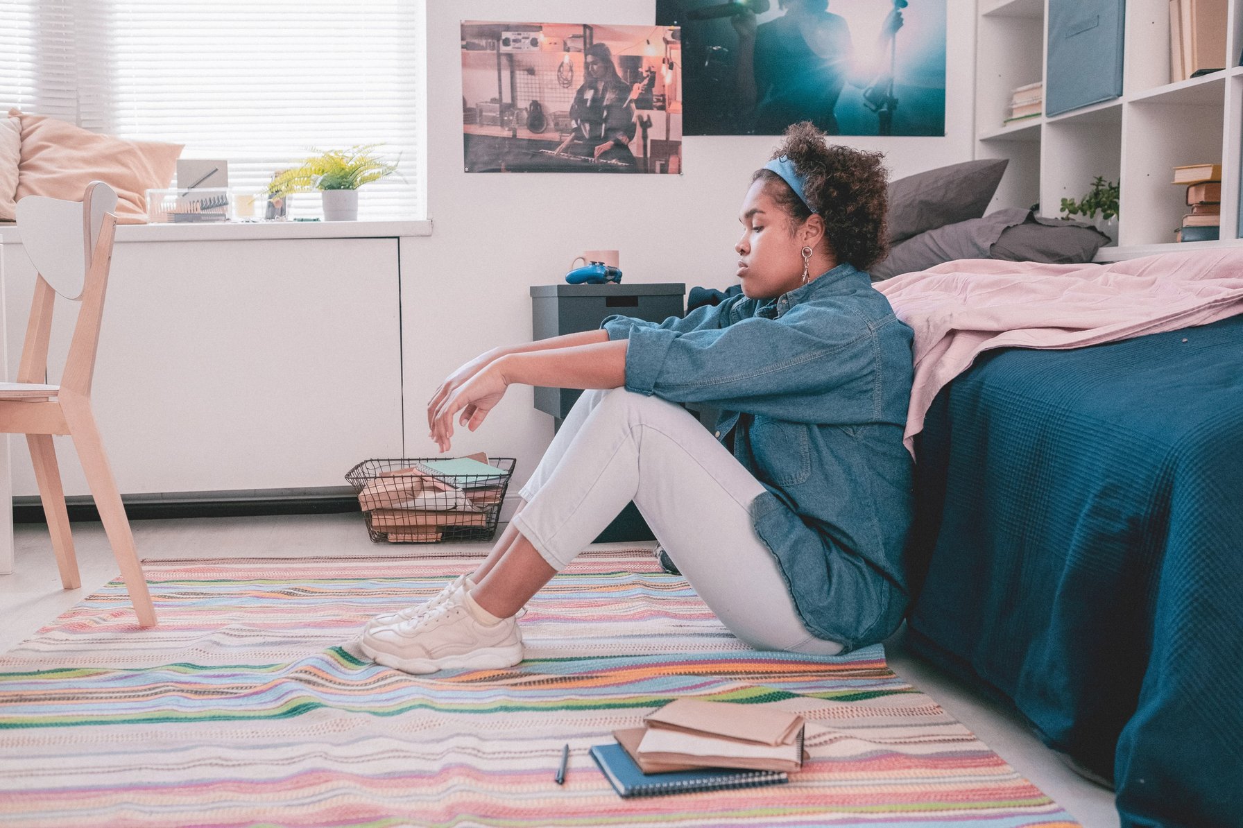 Teen with anxiety sitting against her bed
