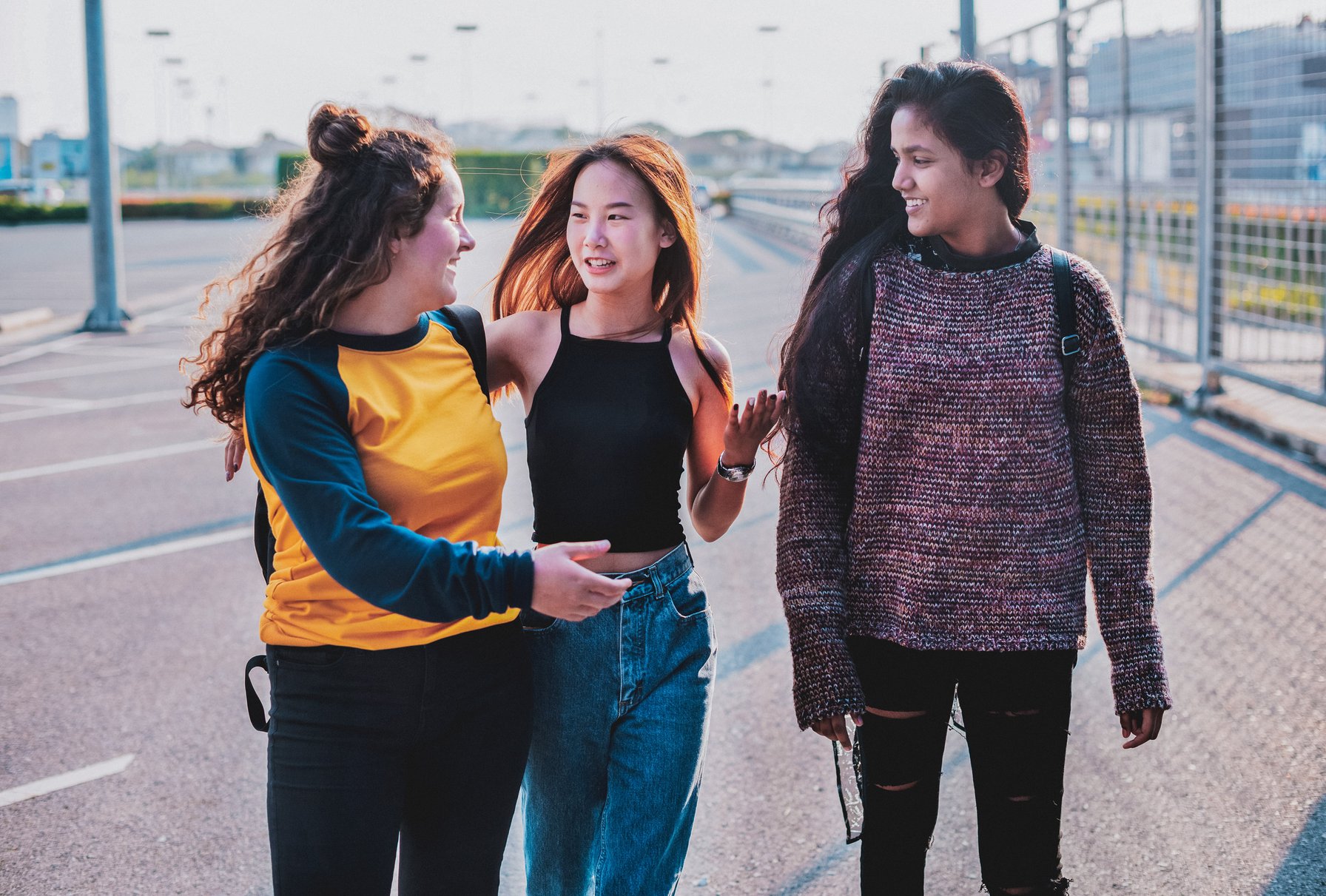 Teens talking and walking in a parking lot